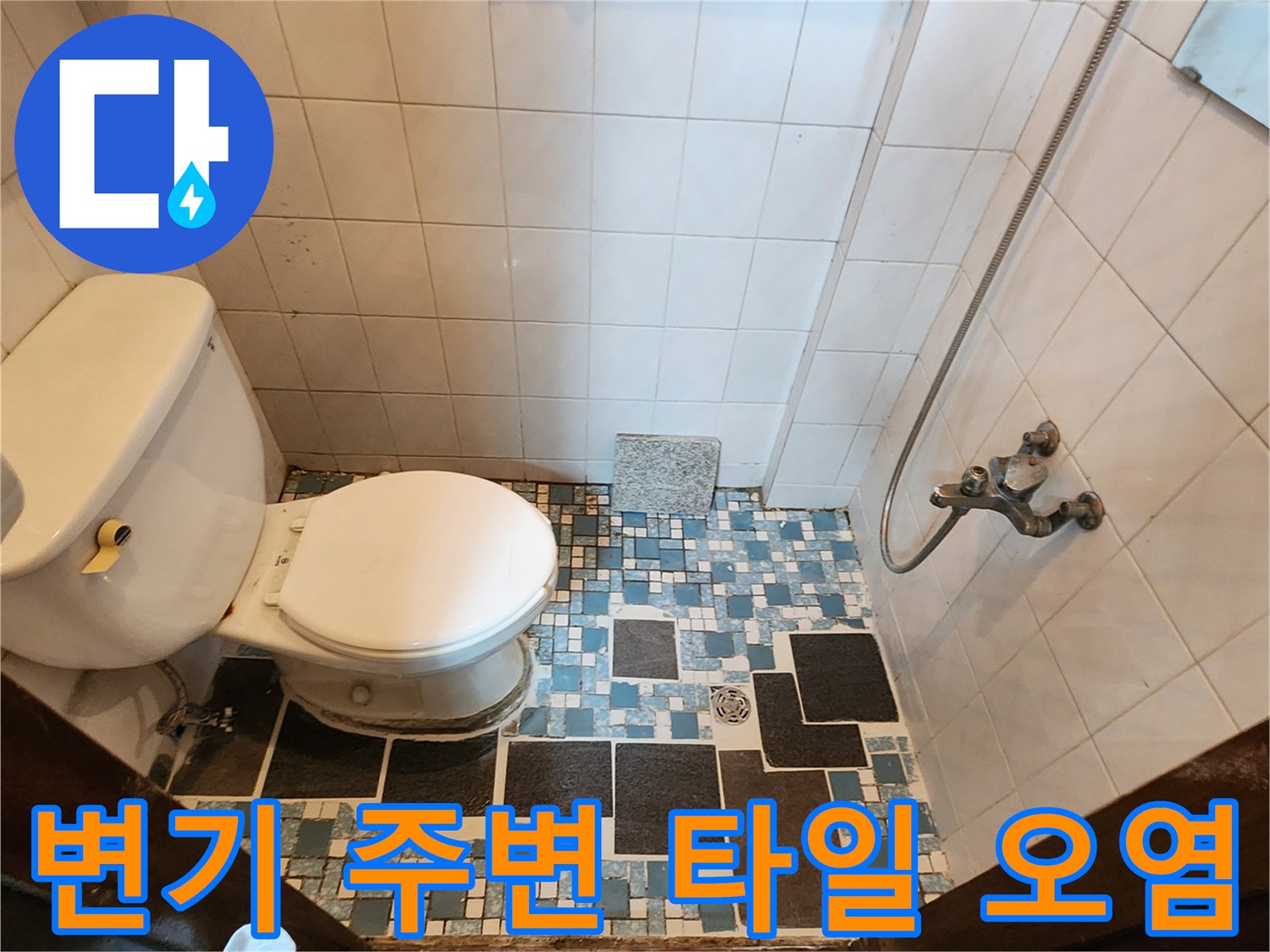 물기가 스며든 듯한 변기 하단과 푸른색 패턴의 바닥 타일 시공 상태