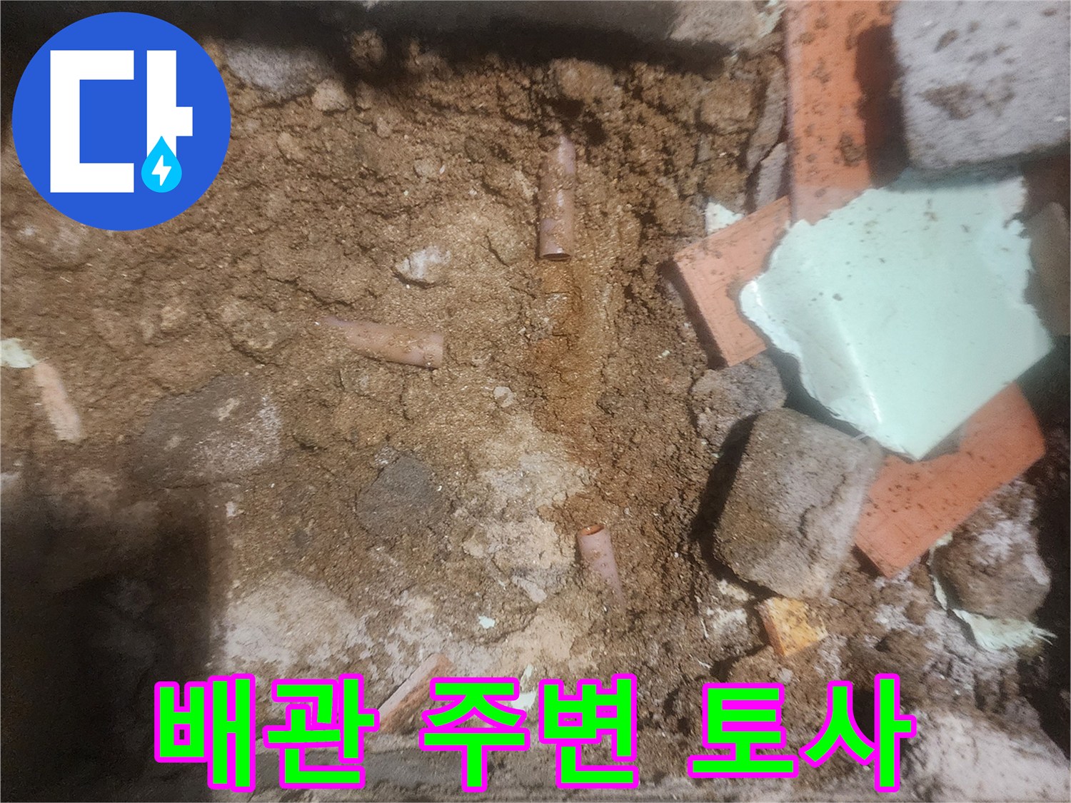 물샘이 발생한-배관 주변의 젖은 흙과 파편들