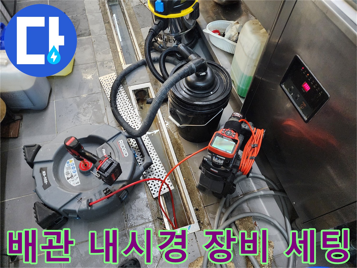 트렌치 배수구 근처에 놓인 전문 배관 내시경 카메라와 전동 장비