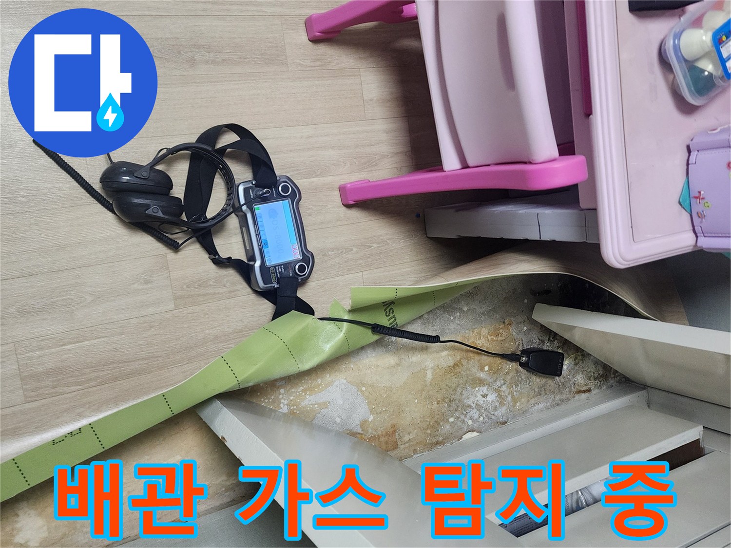 바닥 틈새로 가스를 넣어 누수 지점을 찾는 전문 장비 운용 모습