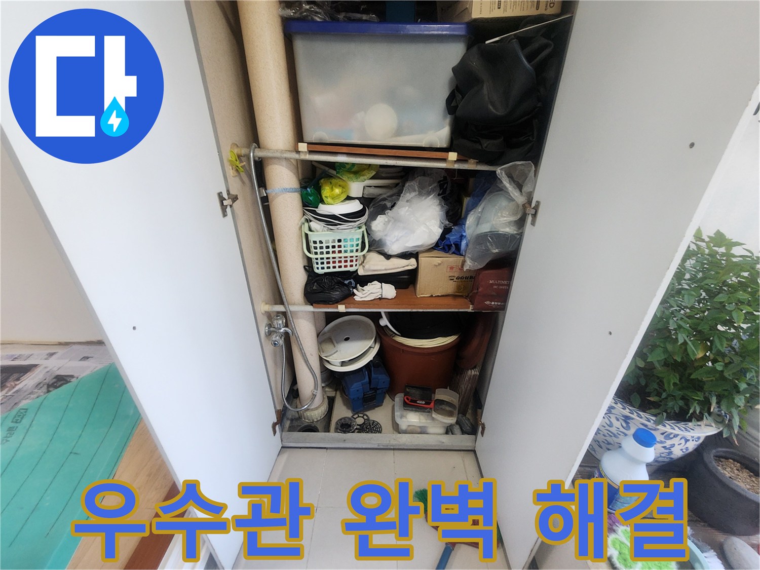 베란다에 설치된 수납장-내부에 우수관이 지나가는 모습-다양한 물건들이 수납되어 있습니다