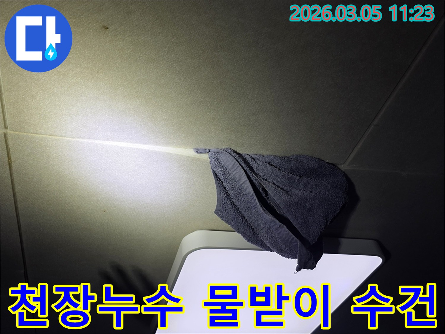 천장에서-물이-새어-나와-수건으로-받고-있는-긴급-누수-상황을-보여주는-이미지