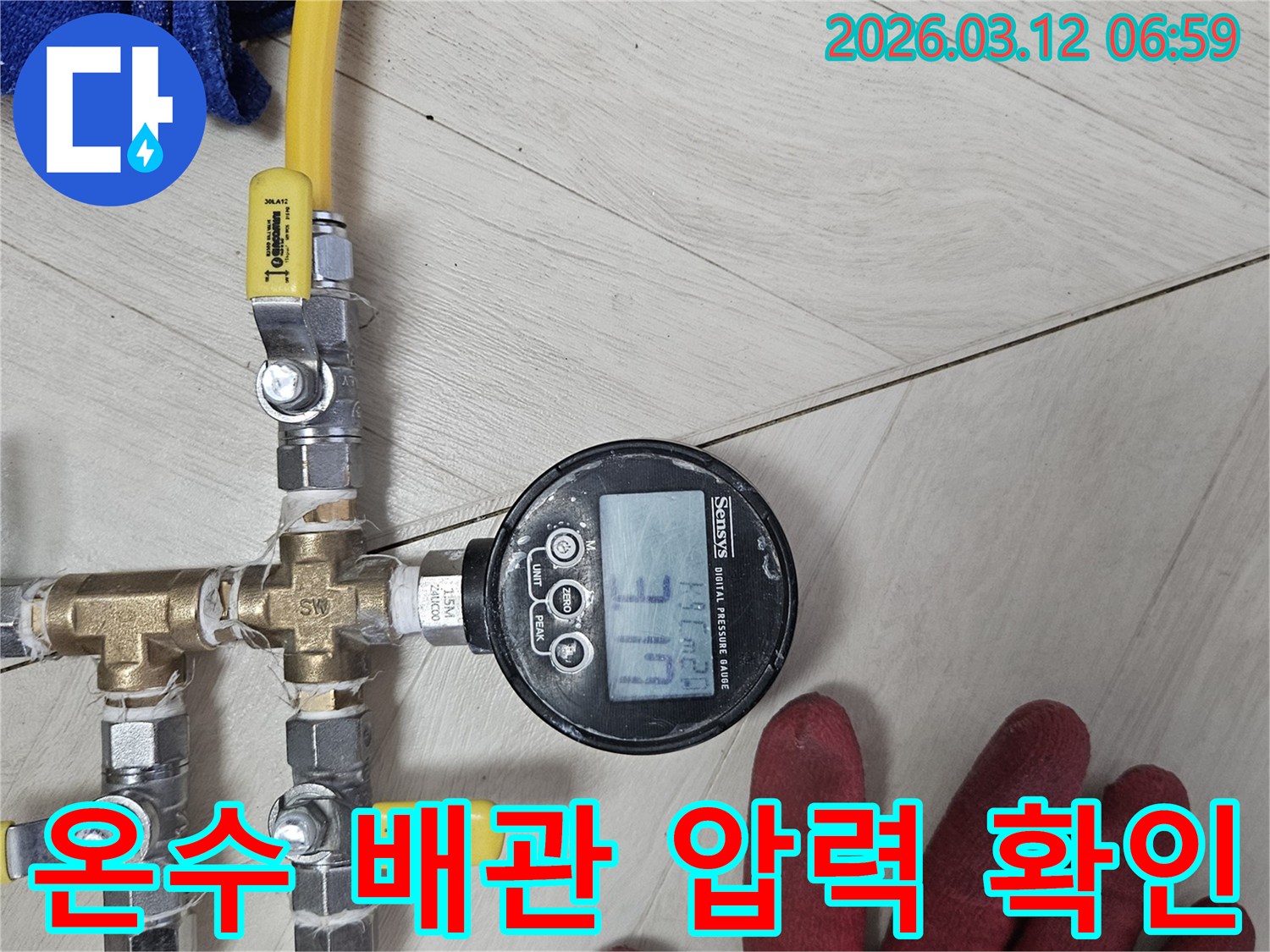 누수-탐지-전문가가-첨단-디지털-압력계로-배관-압력을-정밀하게-측정하여-온수-배관-누수-원인을-신속하게-파악하는-모습