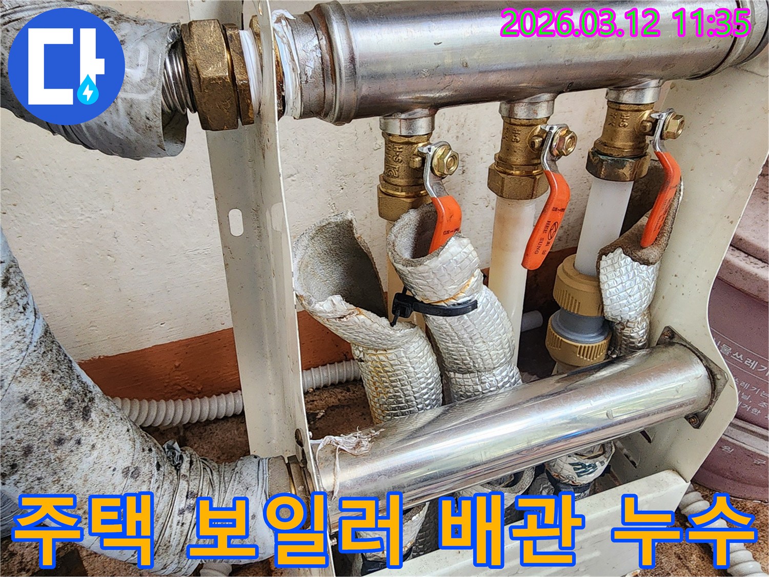 주택-내부-보일러-분배기-배관의-손상된-단열재와-누수-흔적을-보여주는-현장-사진