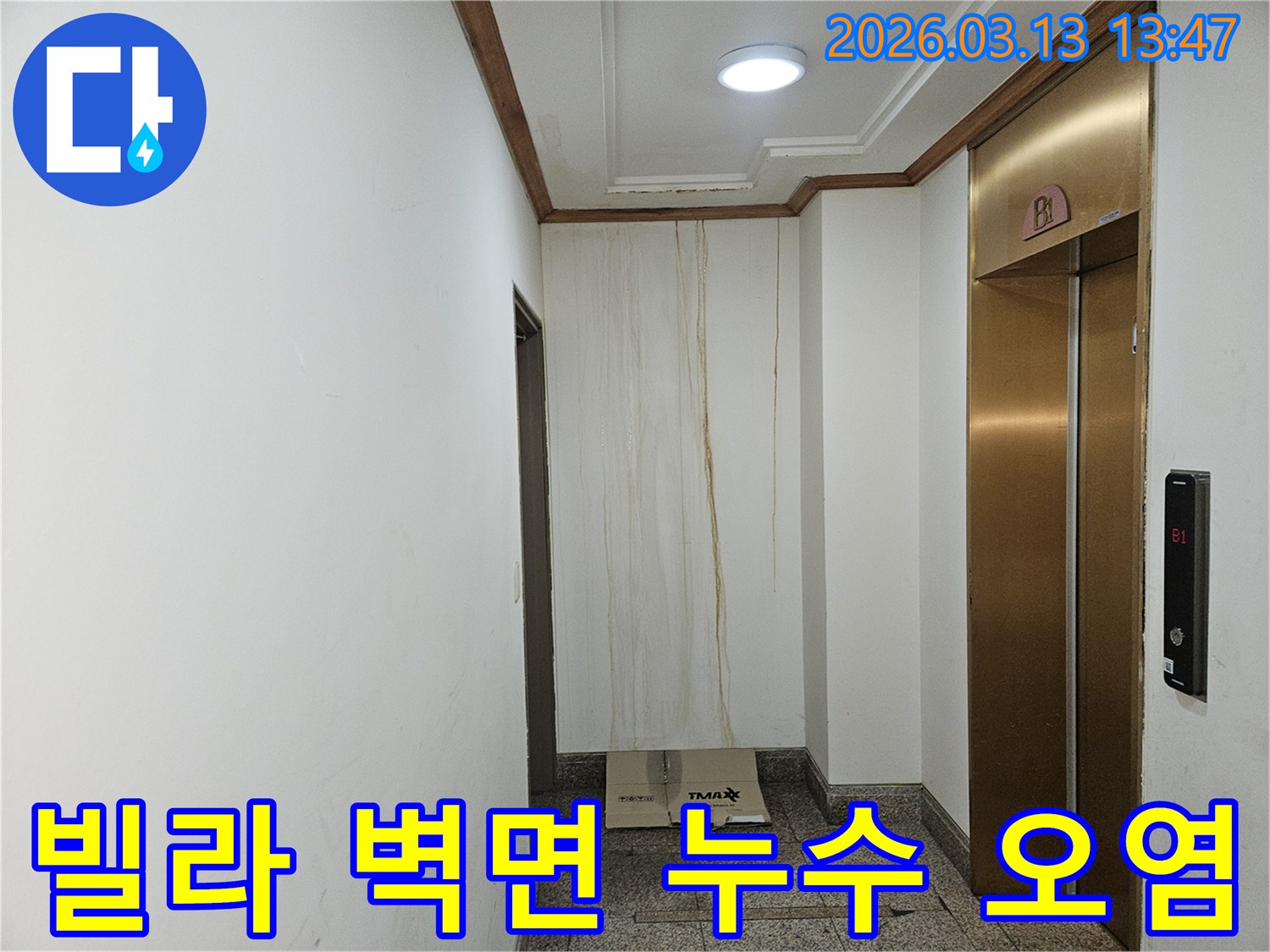 이 사진은 빌라 복도 벽면에 발생한 누수로 인해-물이 흘러내려 심하게 오염된 모습을 보여줍니다-천장과 벽의 경계에서 누수가 시작된 것으로 보입니다