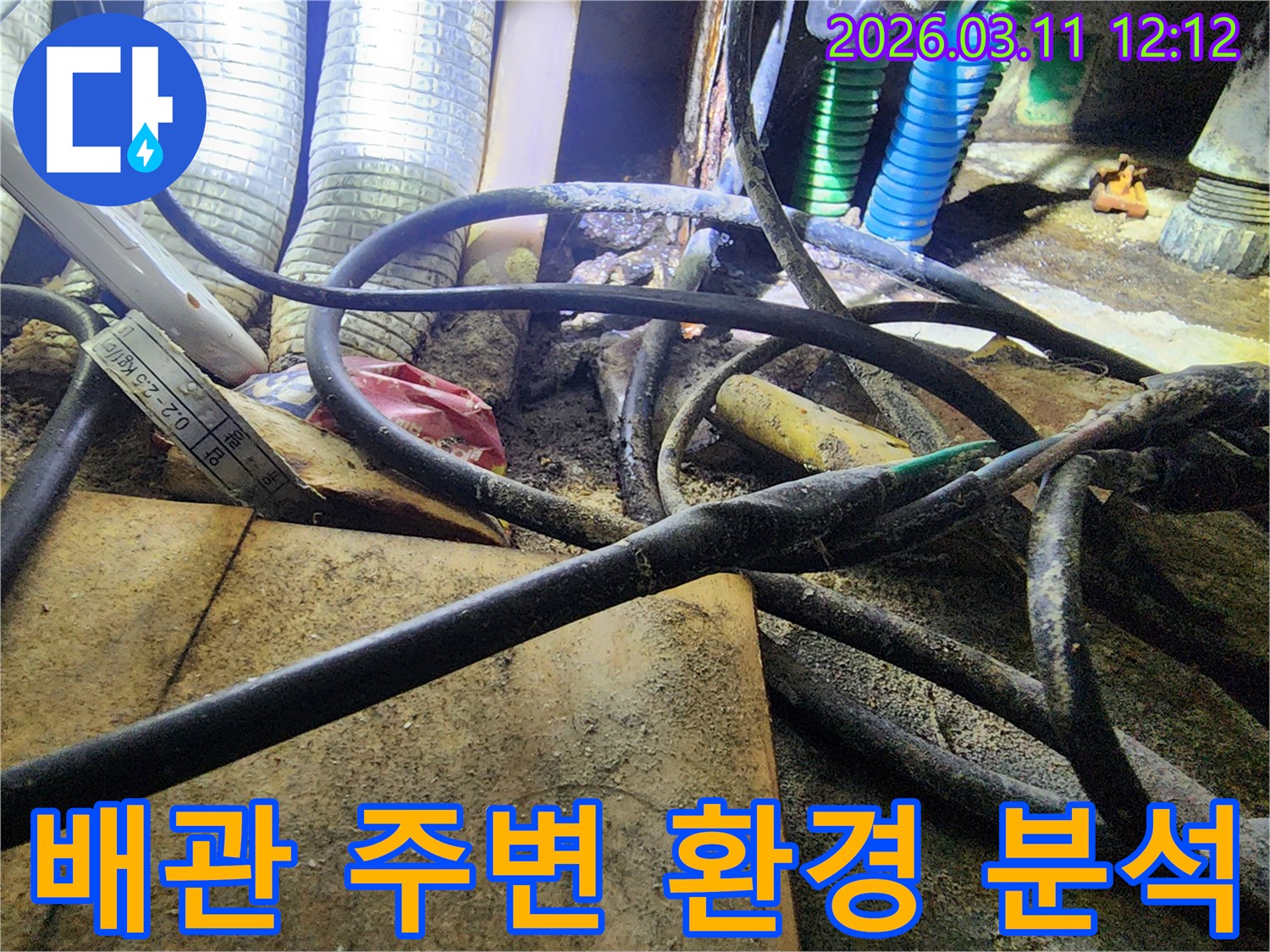 누수-현장에서-복잡하게-얽힌-배관과-전선-그리고-주변의-오염된-환경을-분석하는-모습을-보여주는-사진입니다.