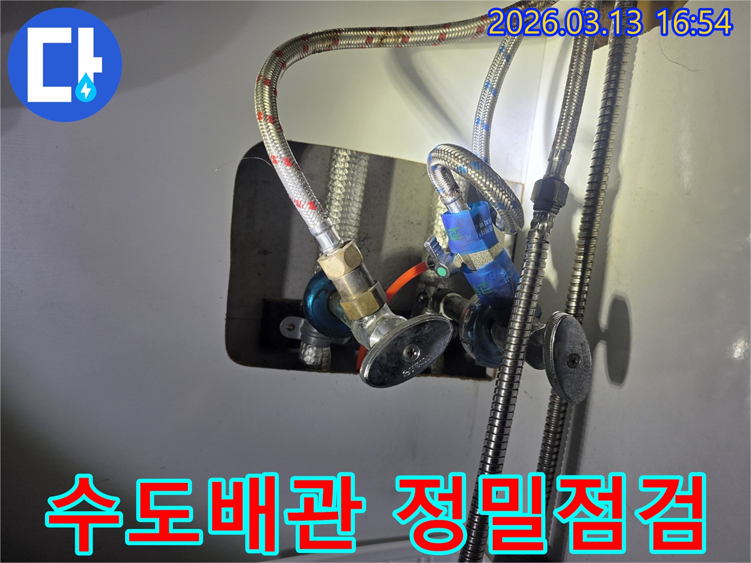 이 이미지는-전문가가-수도배관과-밸브-연결부위를-꼼꼼하게-점검하는-모습을 보여줍니다