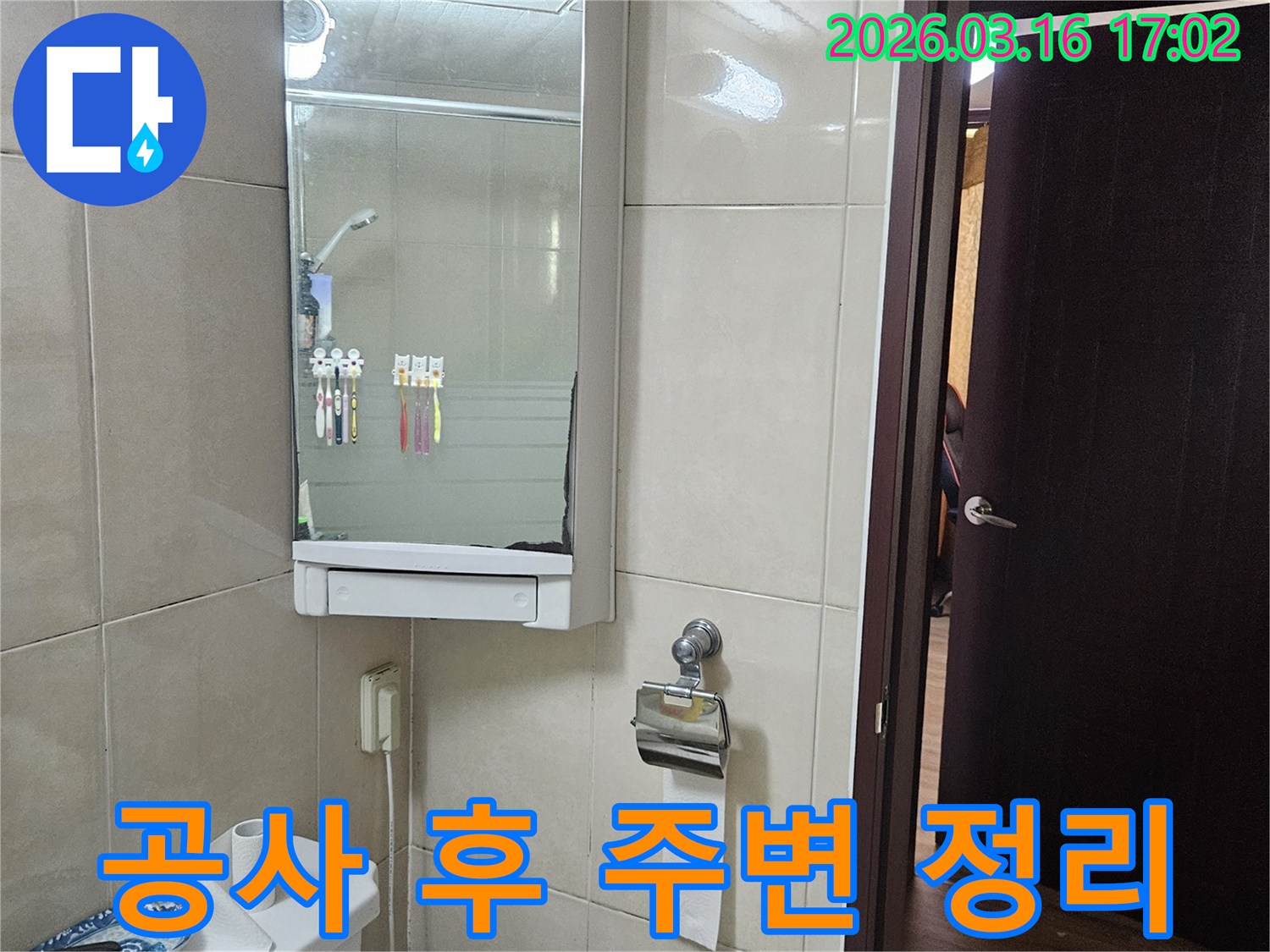 아파트 욕실의-타일 벽면-거울 수납장-변기-창문이 보이는-공사 후 주변 정리 및 청소 현장입니다