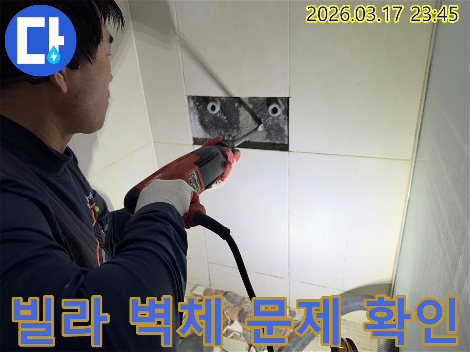 누수 공사 전문가가 빌라 욕실 벽면의 타일을 조심스럽게 파쇄하여-누수 원인 배관의 문제점을 정밀 확인하는 모습입니다.