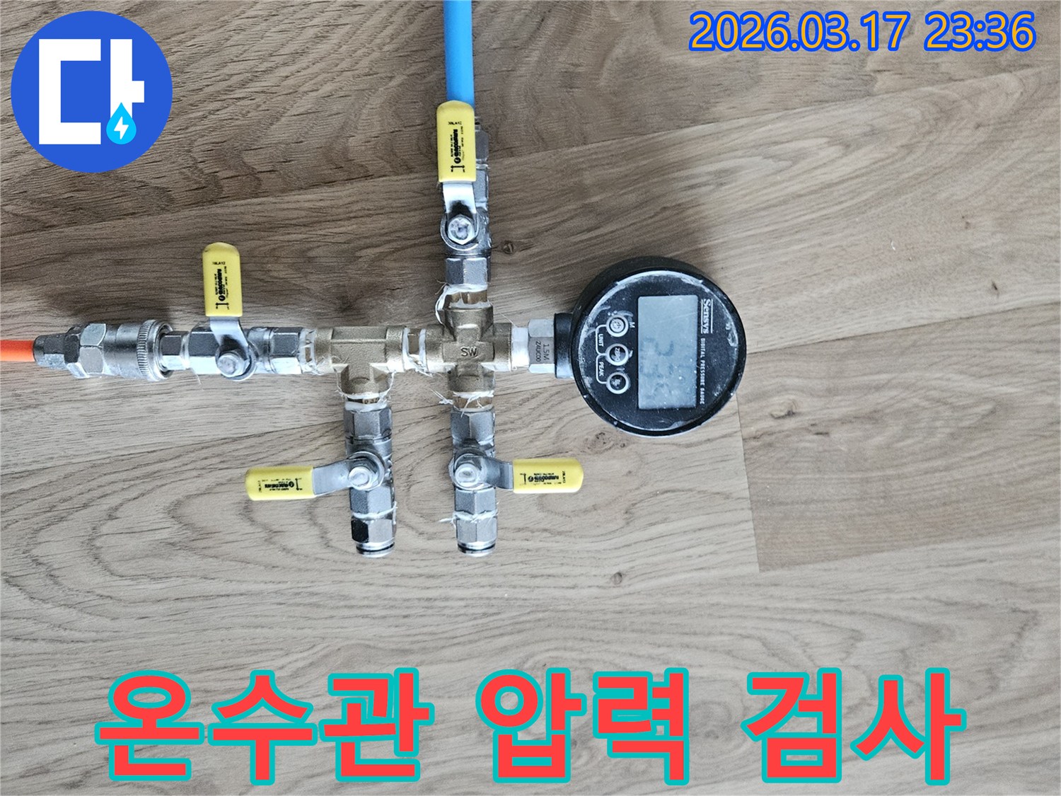 온수 배관의 누수 여부를 확인하기 위해-전문 압력 테스트 장비를 연결하여-정확한 수치를 측정하고 있습니다.
