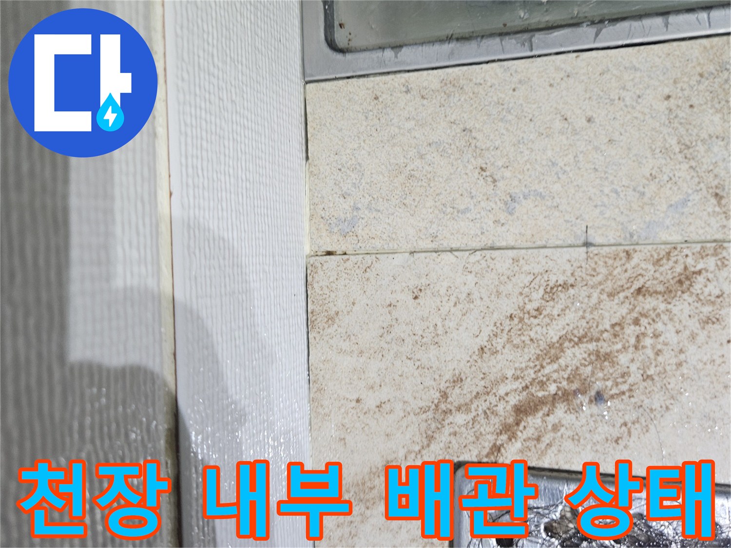 욕실 점검구 내부-배관 주위의 물샘 흔적과 젖은 마감재