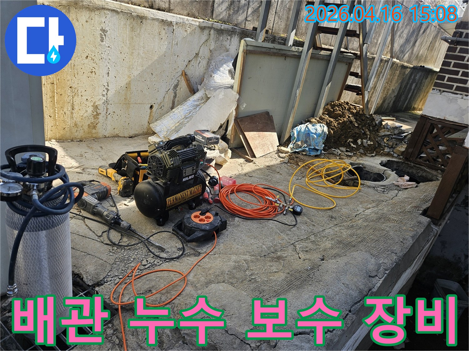 누수 공사를 위한-에어 콤프레셔-함마드릴-호스-전선릴 등-다양한 전문 장비들이-콘크리트 바닥 위에-정돈되어 있는-작업 준비 현장