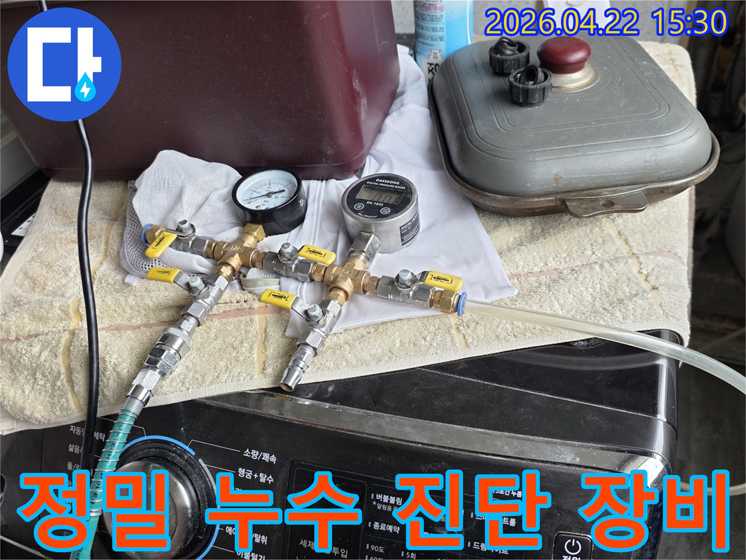 화장실 누수 원인을 찾기 위해-압력 게이지와-유량계가 연결된-전문 탐지 장비로-배관을 점검하는 중입니다.
