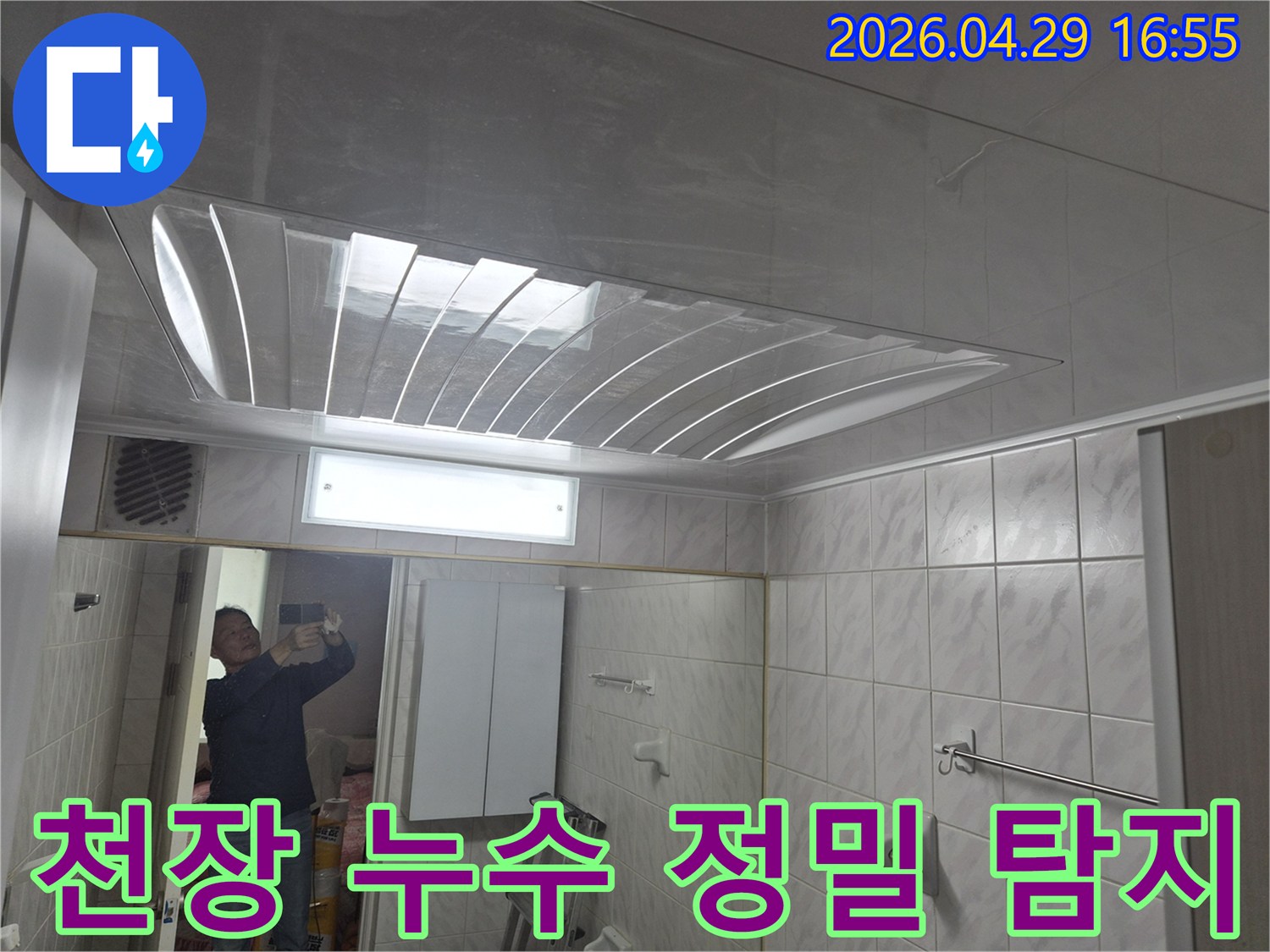 욕실-천장의-돔-형태-마감재와-조명-그리고-거울에-반사된-엔지니어의-모습이-담긴-누수-정밀-탐지-준비-사진