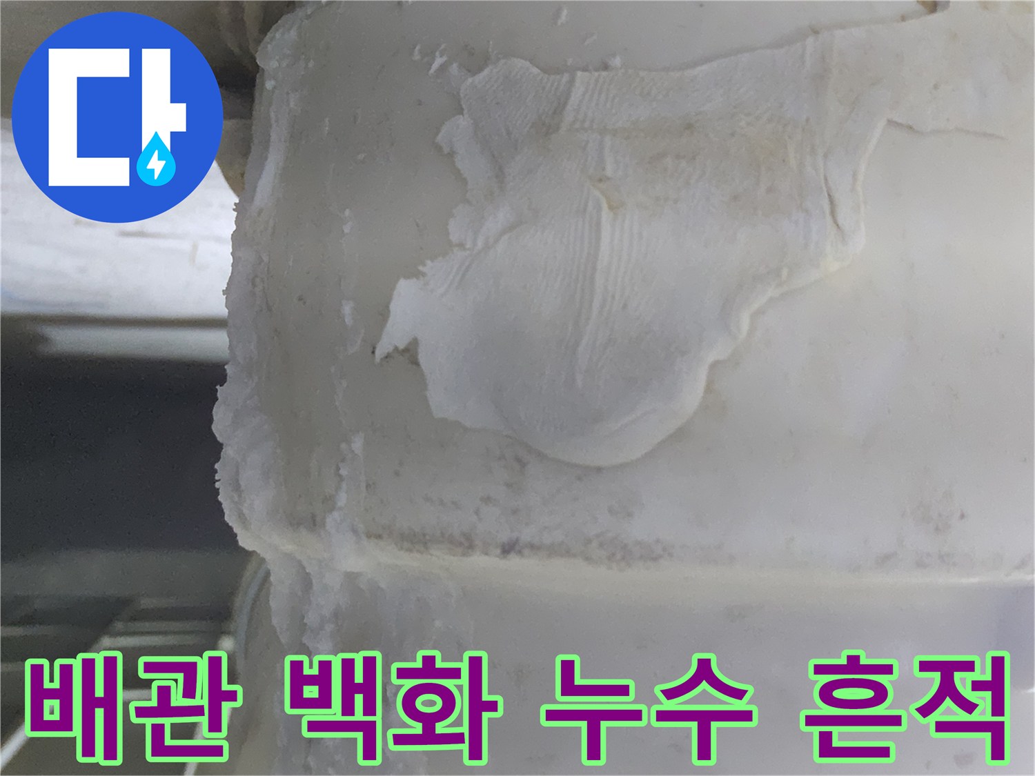 오랜 기간 물이 새면서-하얗게 굳어버린-배관 주변의-석회질 침전물과-물때 흔적을-보여주는 이미지입니다.