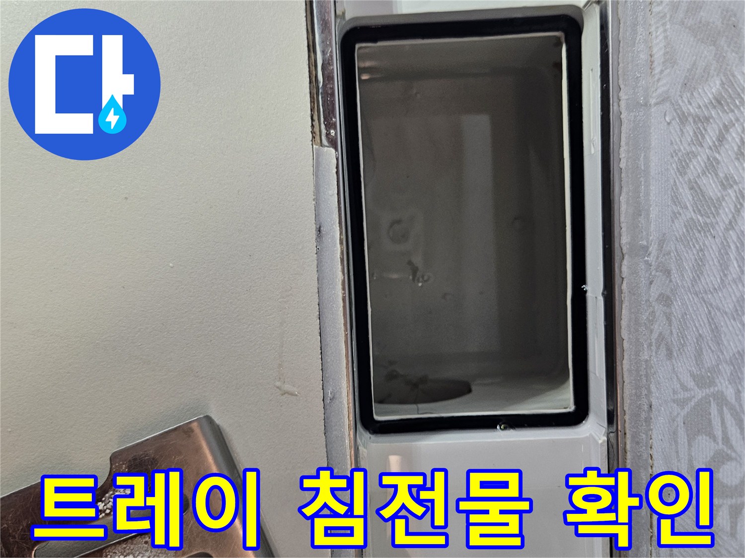 누수-현장에서-배수 트레이-내부의-침전물을-꼼꼼히-확인하는-사진입니다.
