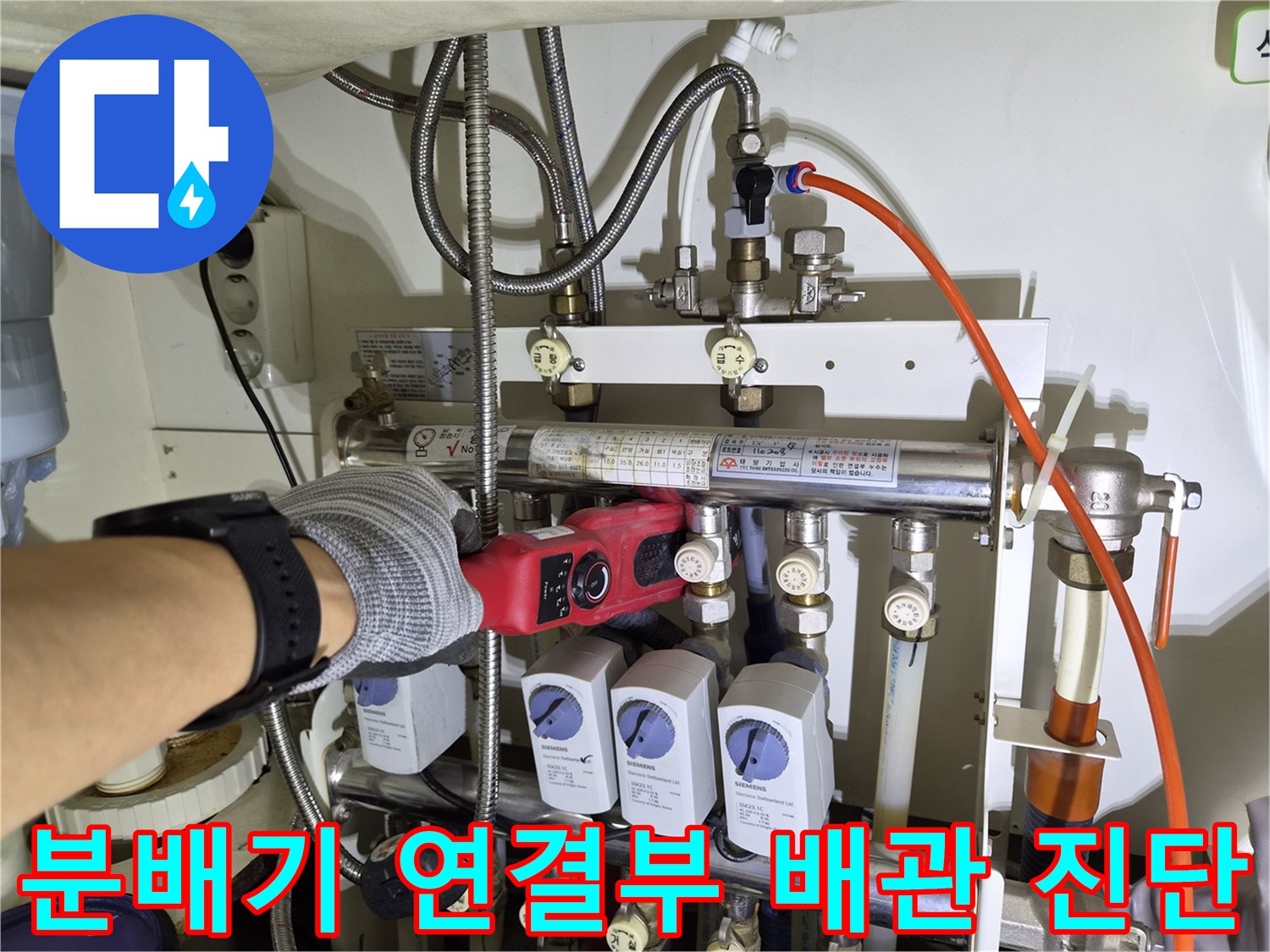 보일러-분배기의-각종-밸브와-연결-배관들을-가스-탐지기로-검사하는-장면
