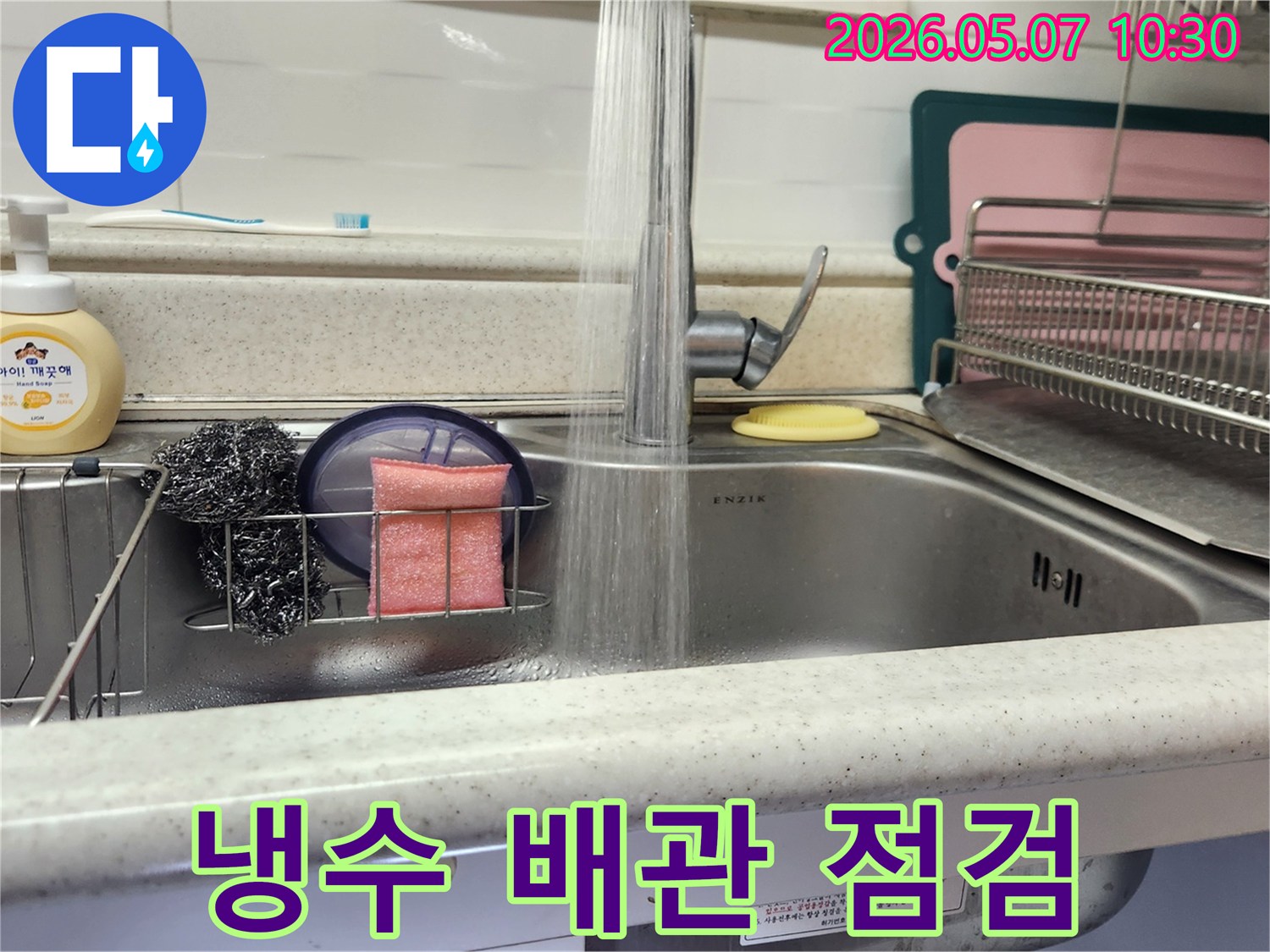 싱크대 수도에서 물이 시원하게 흐르는 모습으로-냉수 배관의 누수 여부를 꼼꼼히 점검하고 있습니다