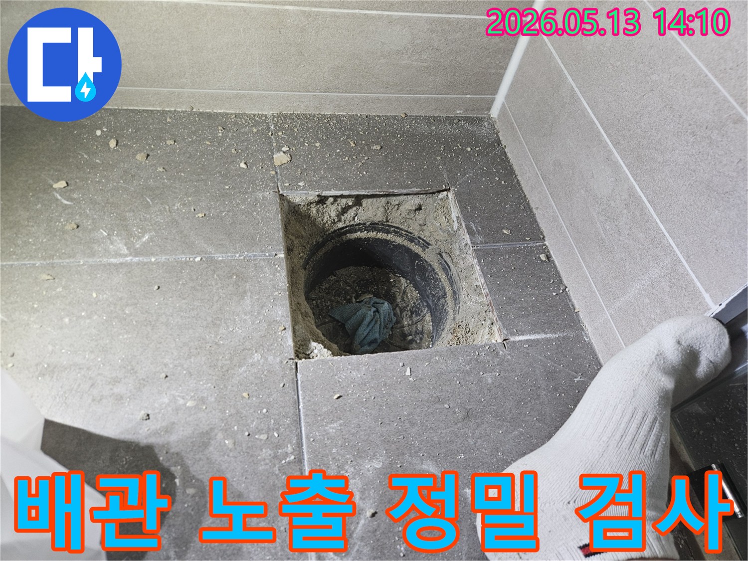 바닥 타일을 걷어내고 누수 원인 배관을 노출시켜 정밀 검사하는 현장입니다-전문가가 꼼꼼하게 누수 지점을 찾아내고 있습니다