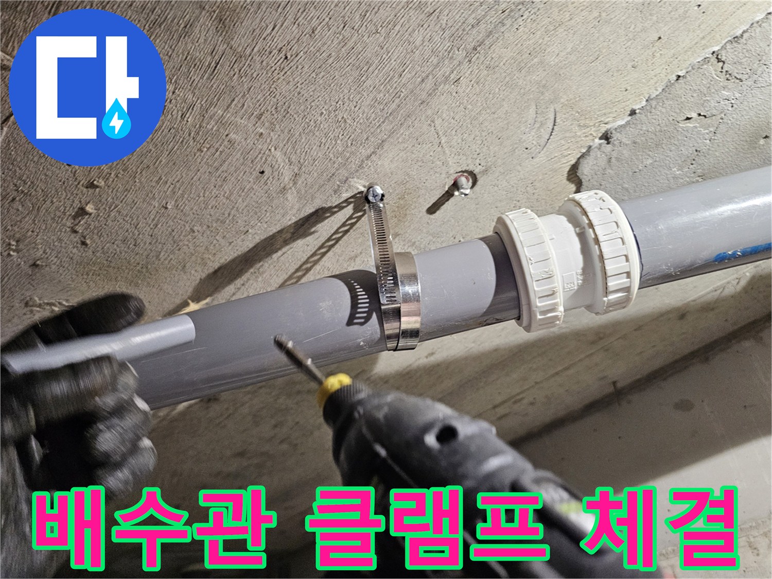 배관 보수 작업-전동 드릴로 밴드 조임 작업을 수행 중