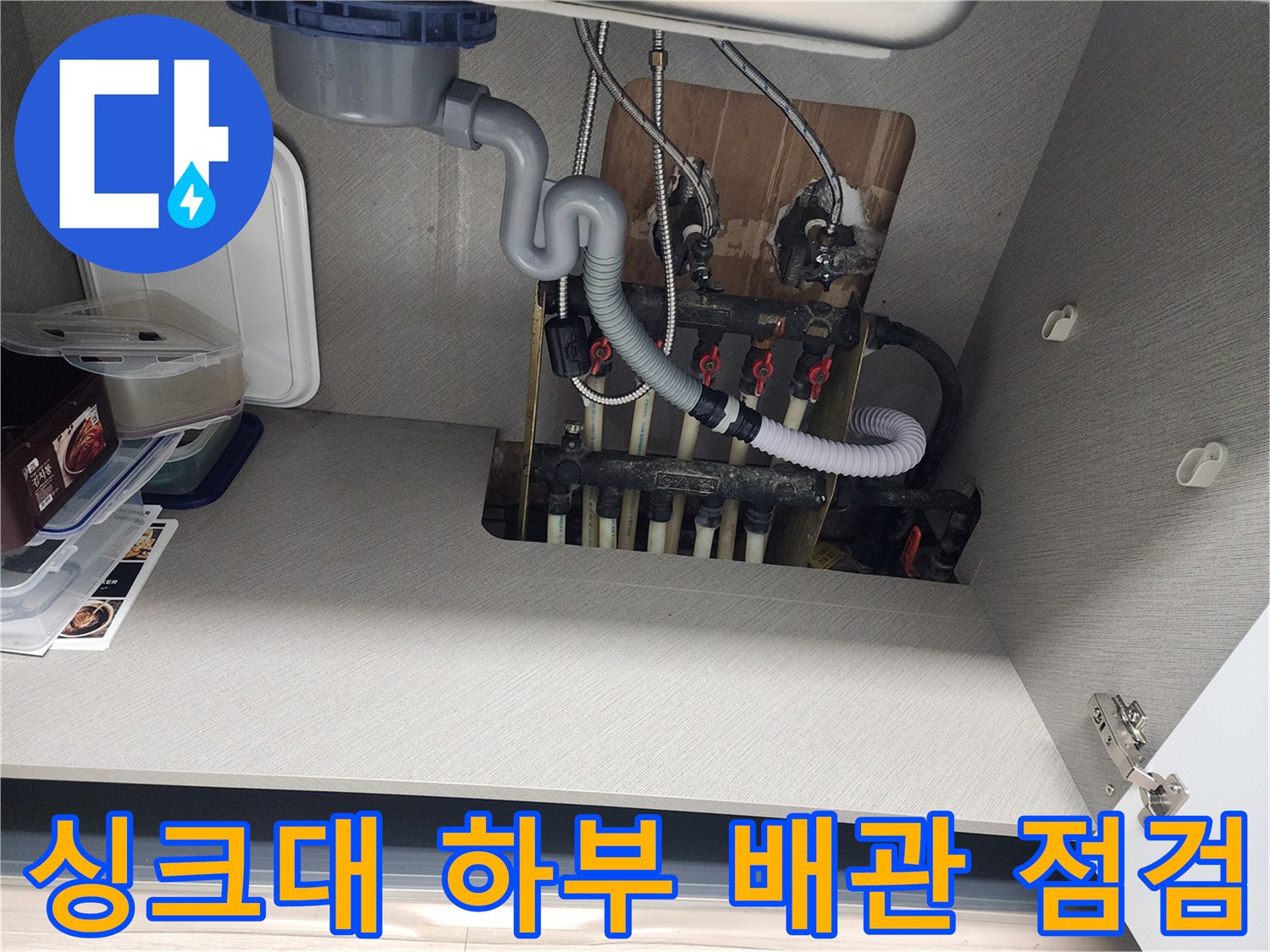 싱크대 내부 공간-분배기 밸브와 연결된 다수의 배관을 촬영한 사진