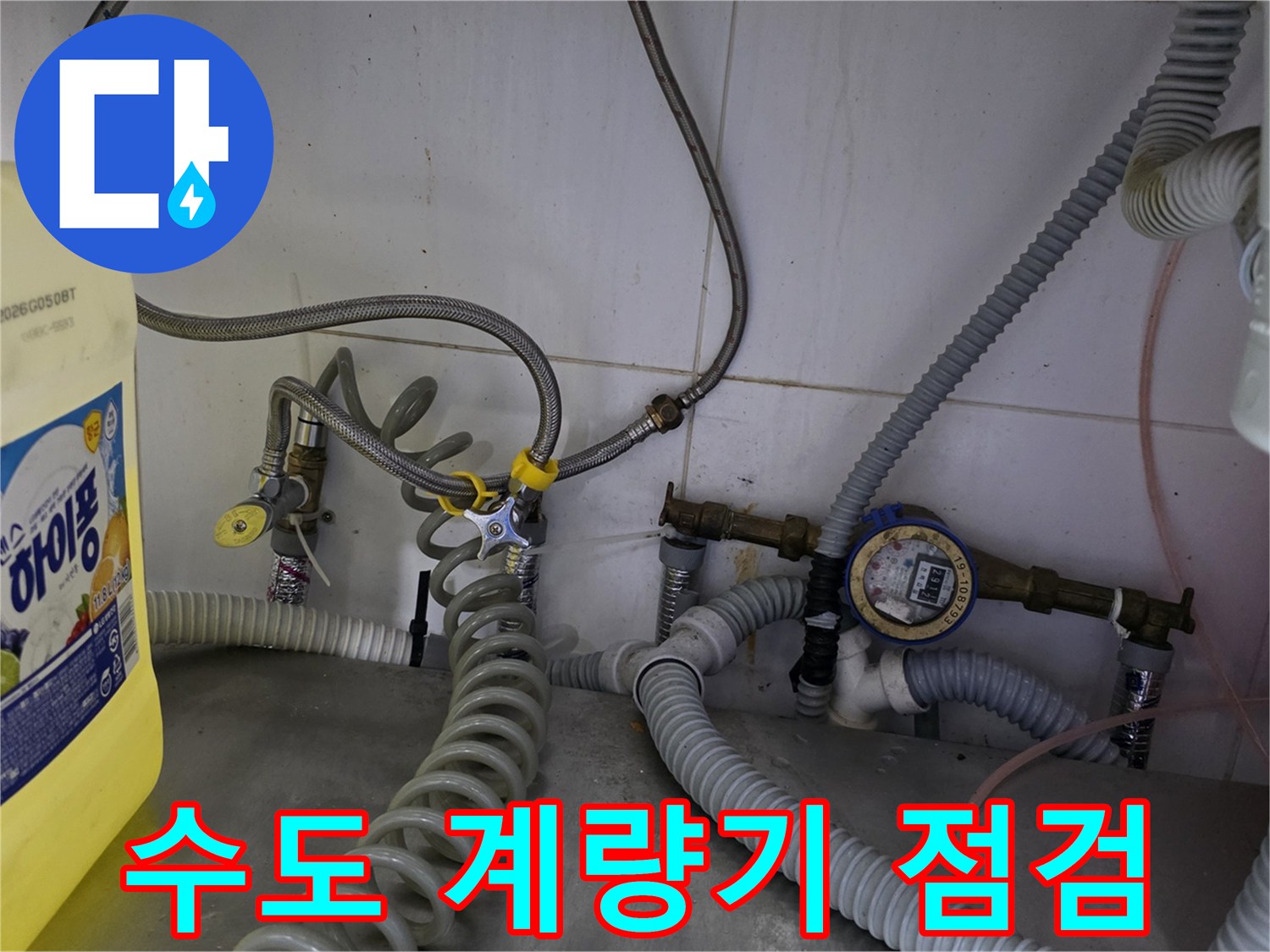 식당 하단부-복잡하게 꼬인 수도 호스와 계량기 연결 부위