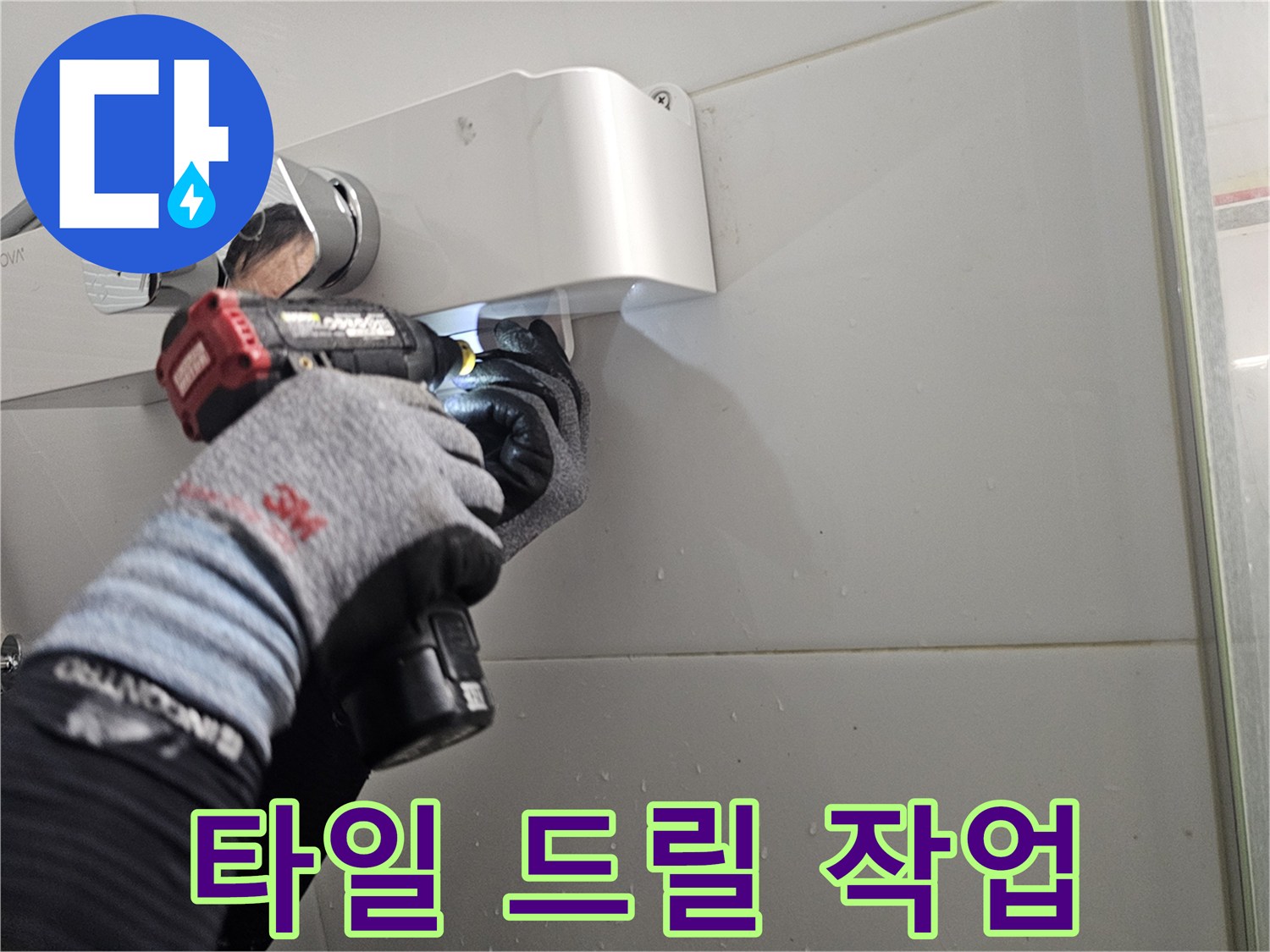 전동 공구를 이용해 수전 설치를 위한 타일 구멍을 만드는 장면