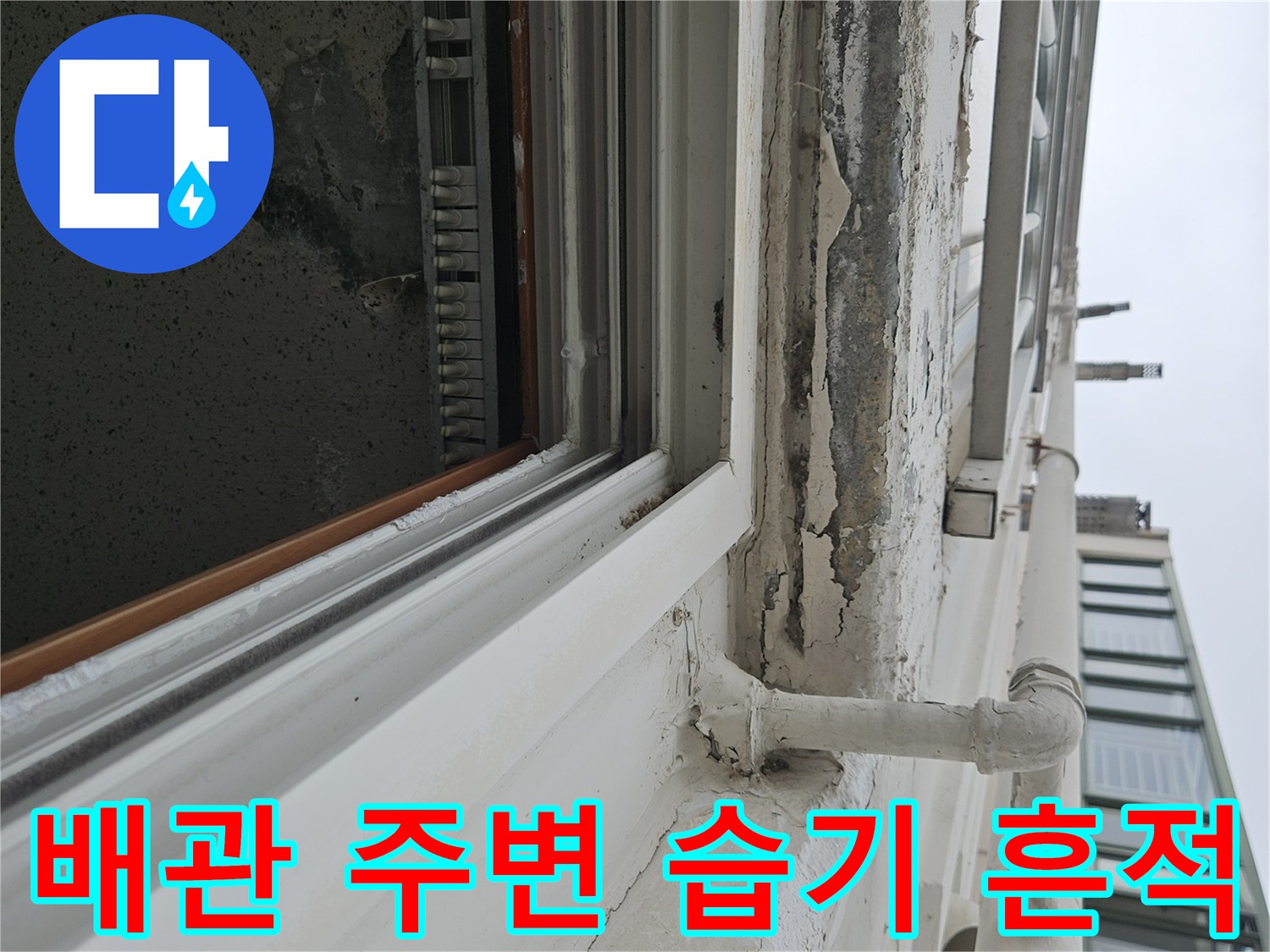 창틀 하부 배관 연결 부위 근처의 천장 마감재가 젖어 있는 모습입니다.