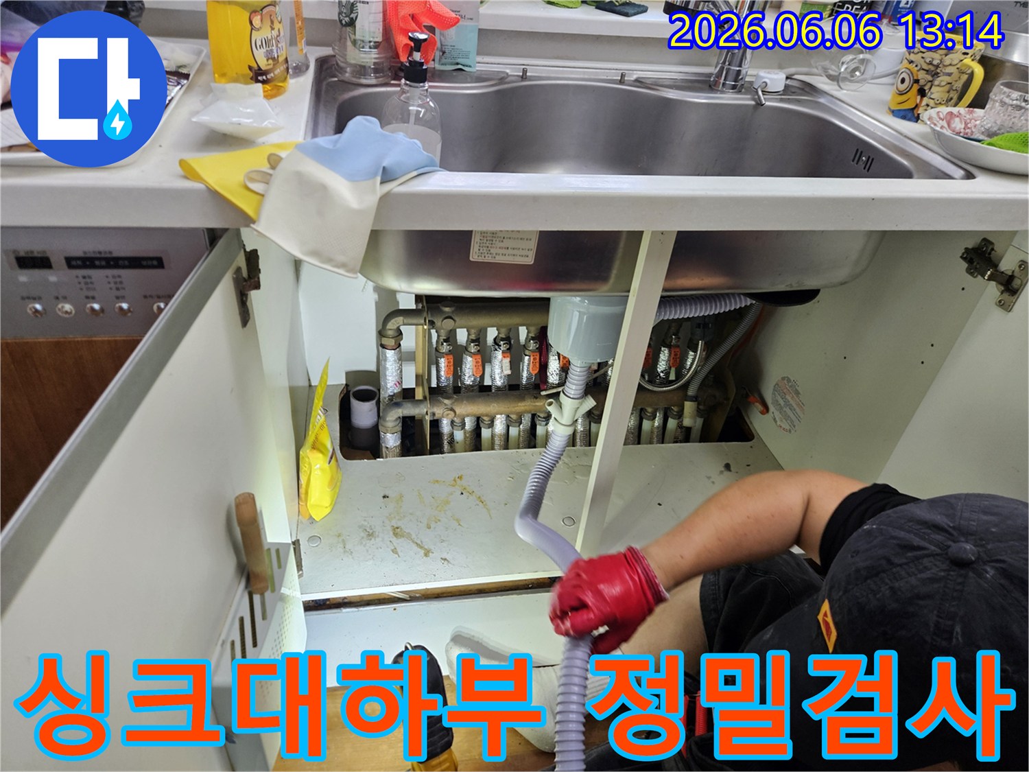 누수-전문가가-싱크대-아래-누수-수리-후-안전성을-확인하기-위해-정밀-검사를-진행하고-있습니다