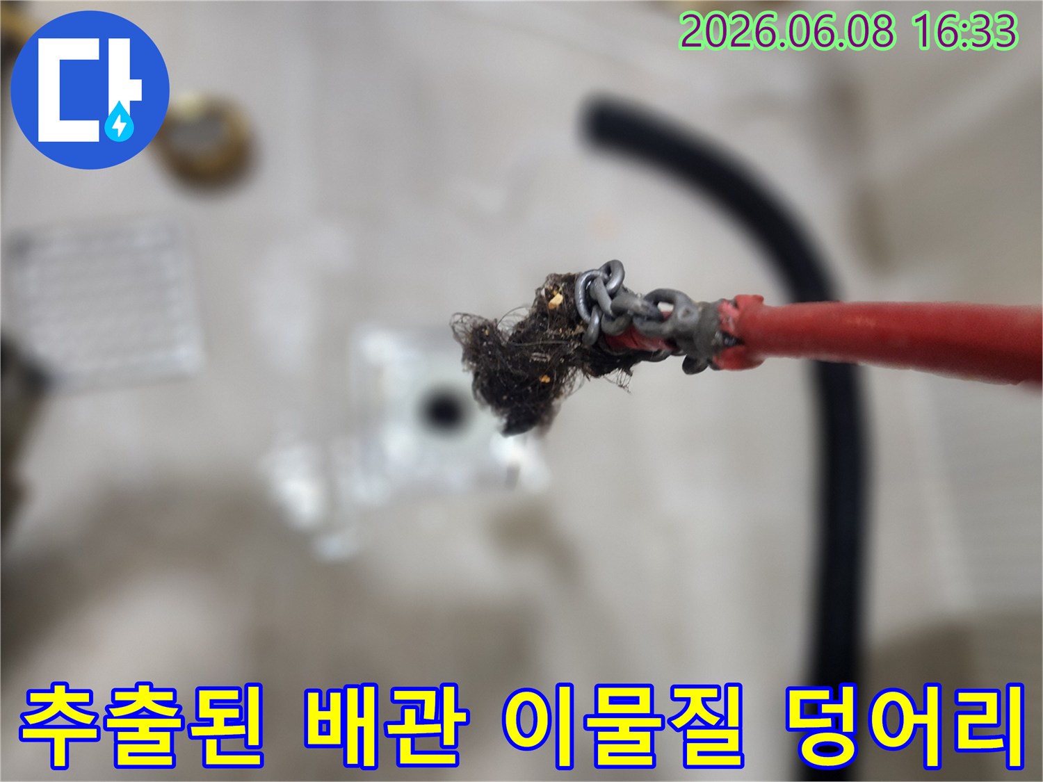 배관 내부에서 제거된-오염된 머리카락과 슬러지 뭉치