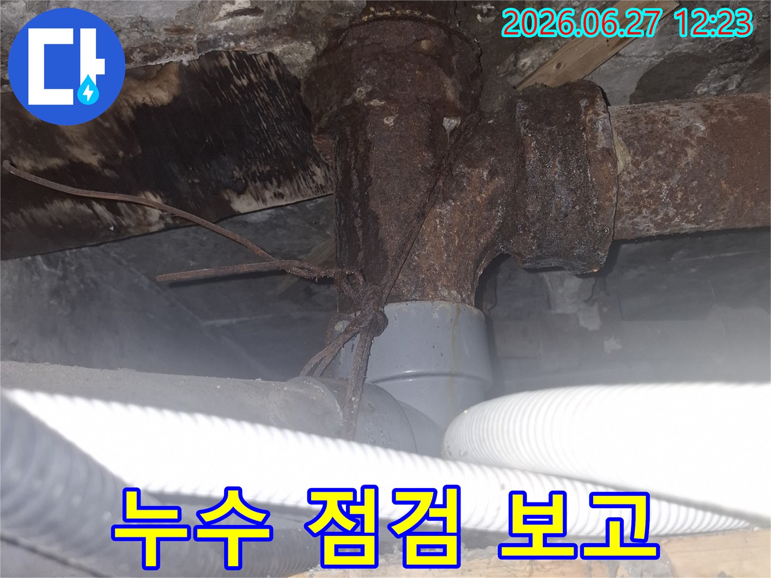 오래된 아파트의 배관에서-누수가 발생하여-정확한 점검 보고를 위해 현장을 점검하는 사진입니다