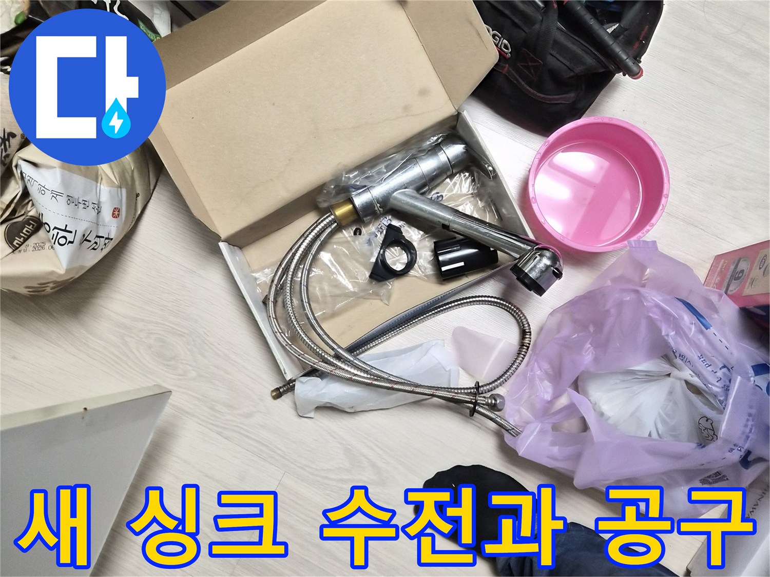 싱크대 교체를 위해 준비된 새 수전 제품과 작업 도구들