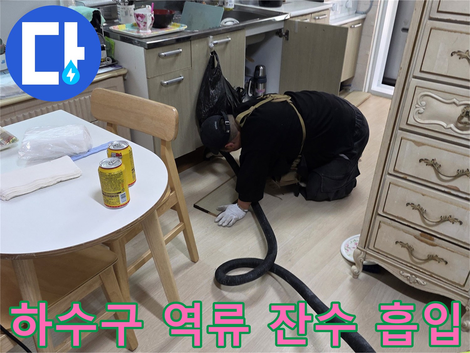 강력한 습식 청소기를 사용하여 배관 주변의 고여 있는 물을 흡입하는 장면