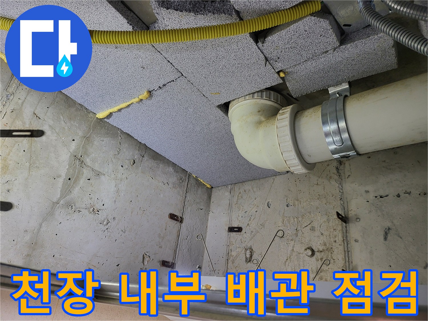 PVC 하수 배관과 노란색 보온재가 설치된 천장 내부 모습