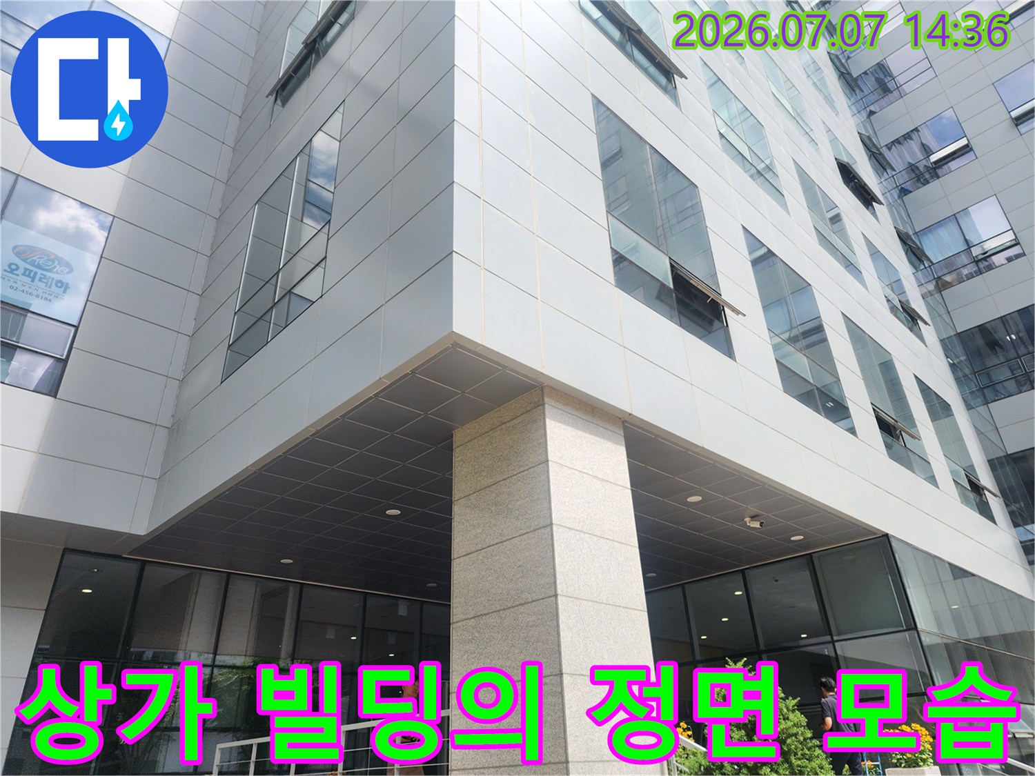 그레이 톤의 석재 마감과 유리창이 인상적인 상업용 건물 외관