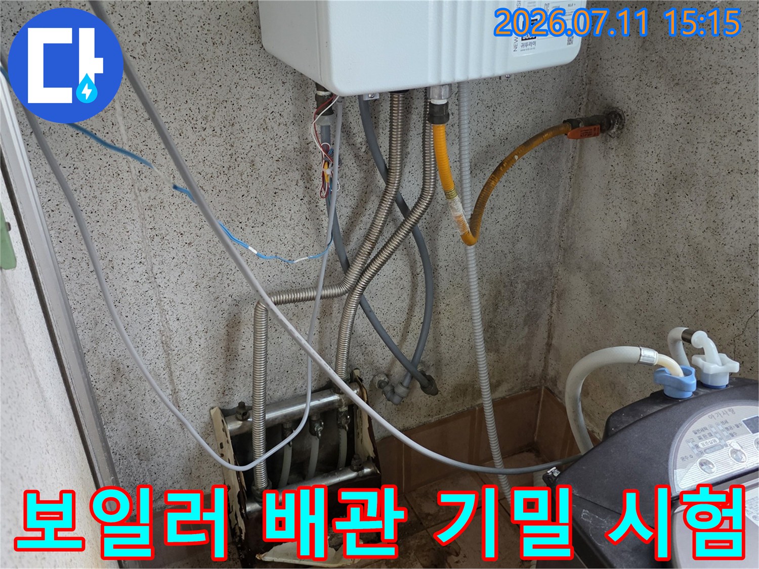 보일러실 배관에 공압 장비를 연결하여 누수 여부를 점검하는 모습