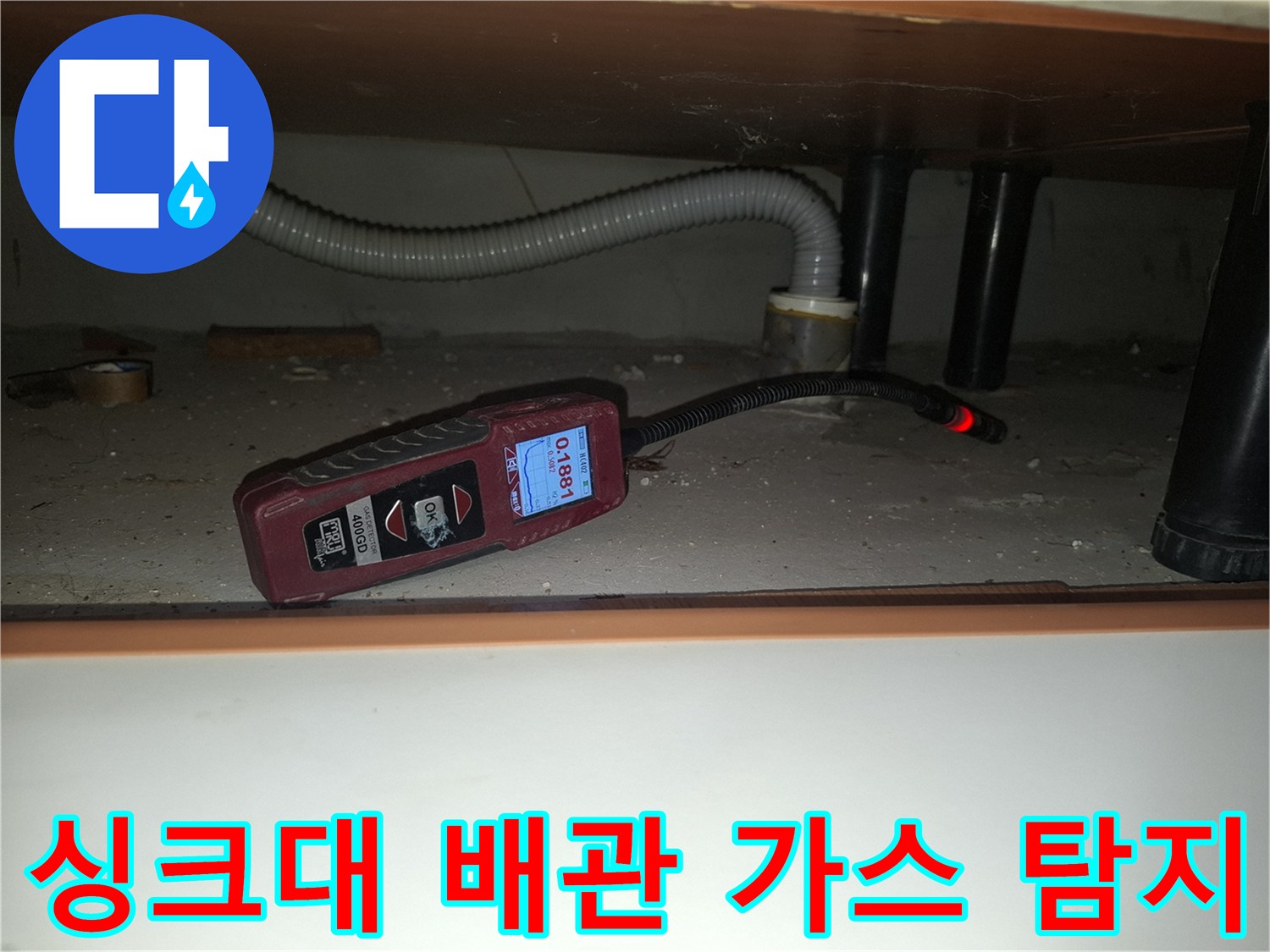 싱크대-하단-배관-주변을-가스-탐지기로-조사하며-수치를-확인하는-장면
