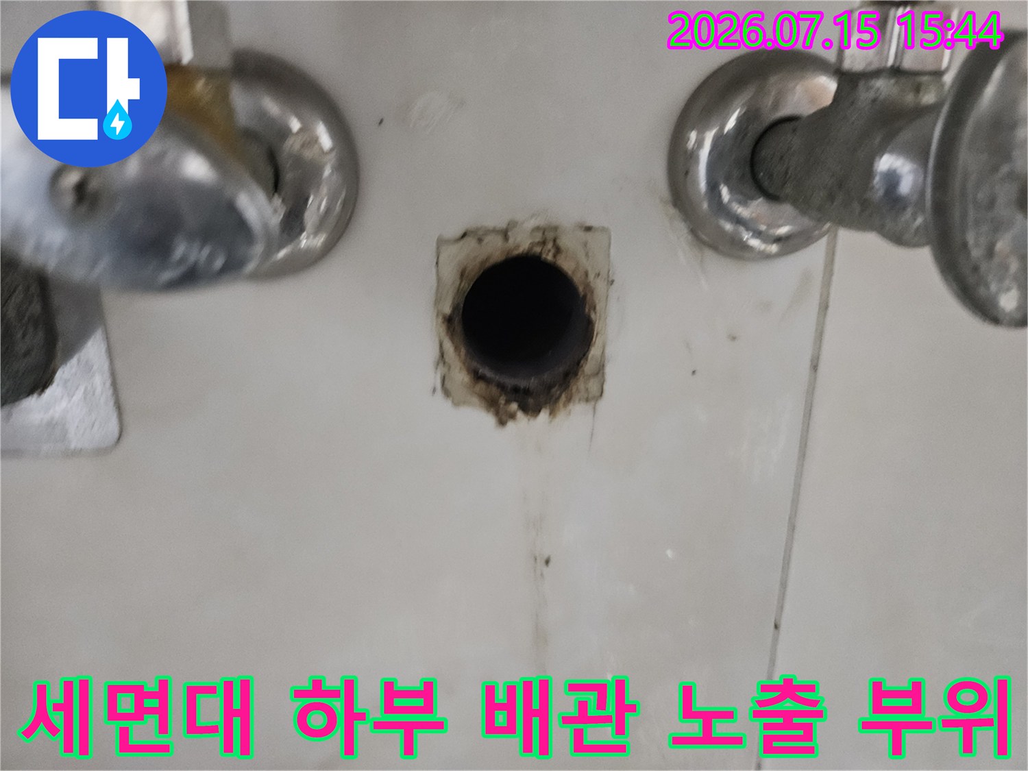세면대 아래쪽을 확인하기 위해 타일을 제거한 후 노출된 파손된 배관 연결부