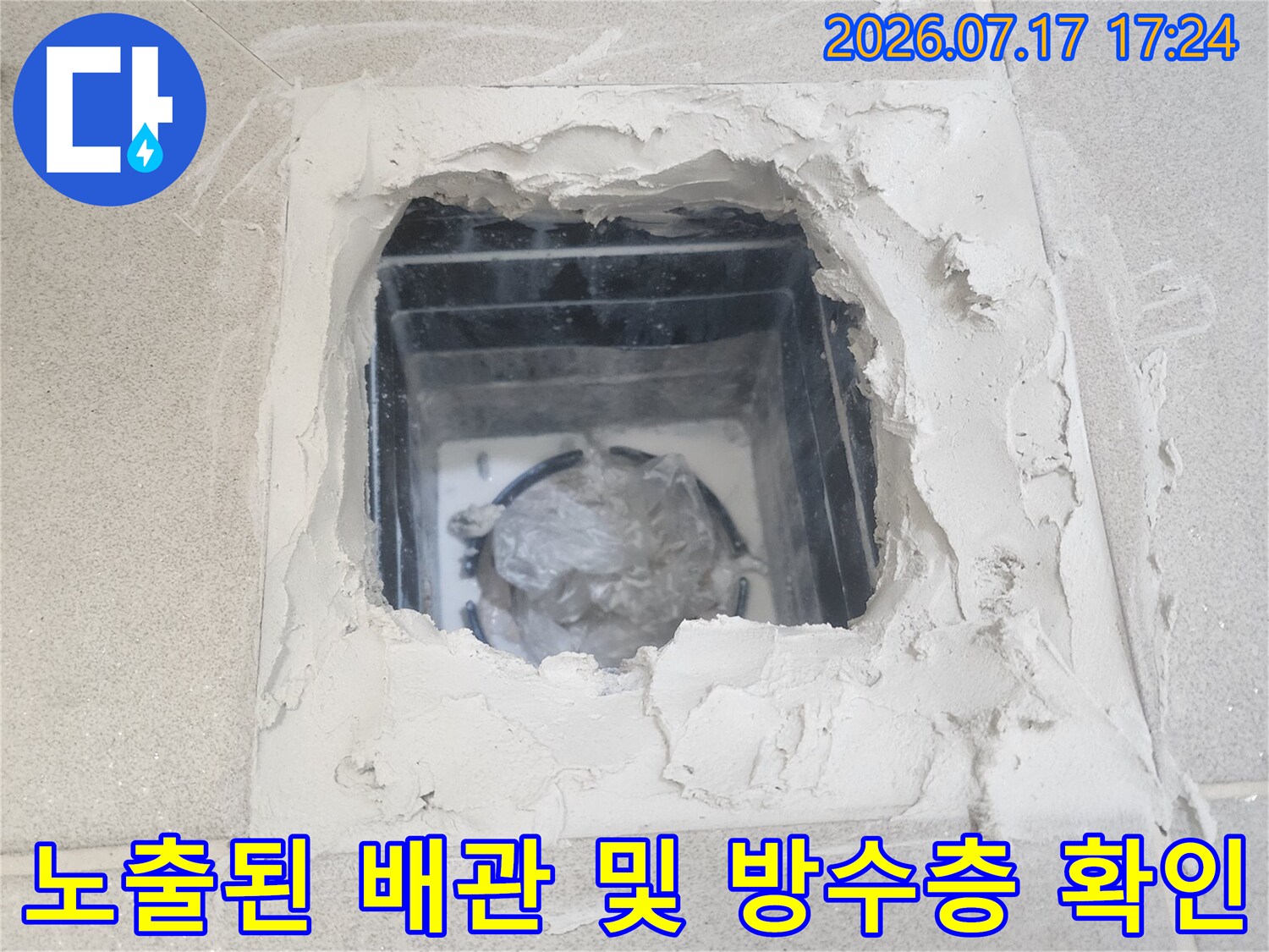 파손된 타일 사이로 드러난 천장 내부 구조와 배관 연결부 점검
