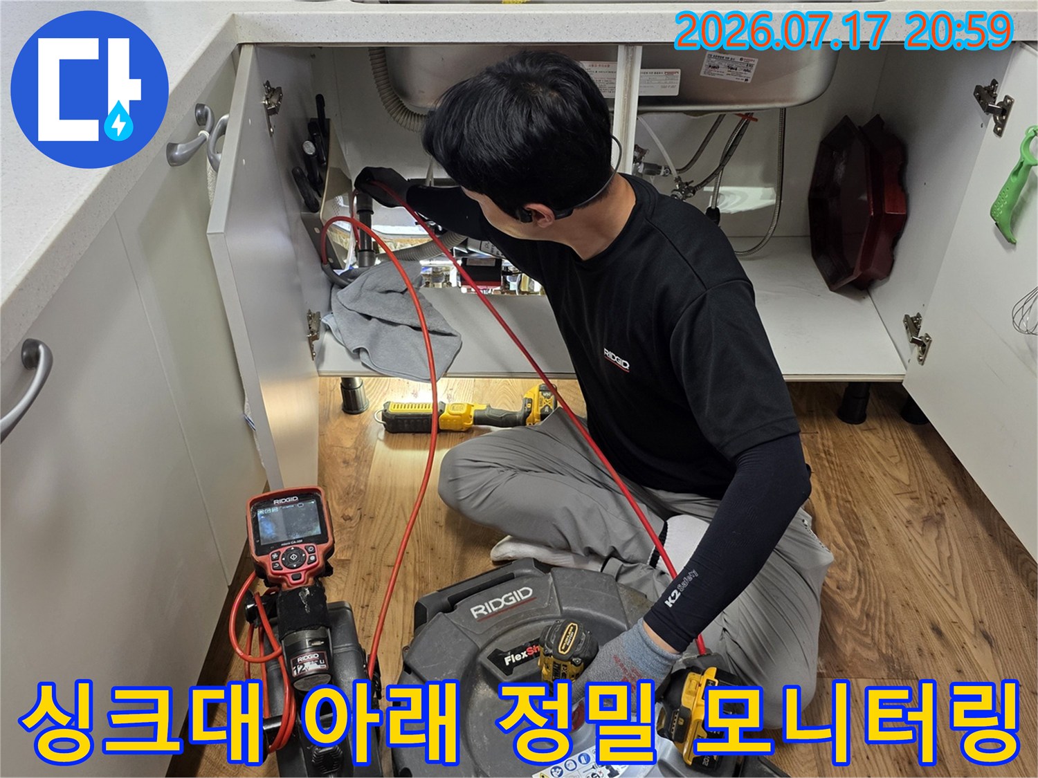 장비를 활용해 싱크대 하부 공간에 위치한 각종 배관들을 다각도로 점검하는 모습