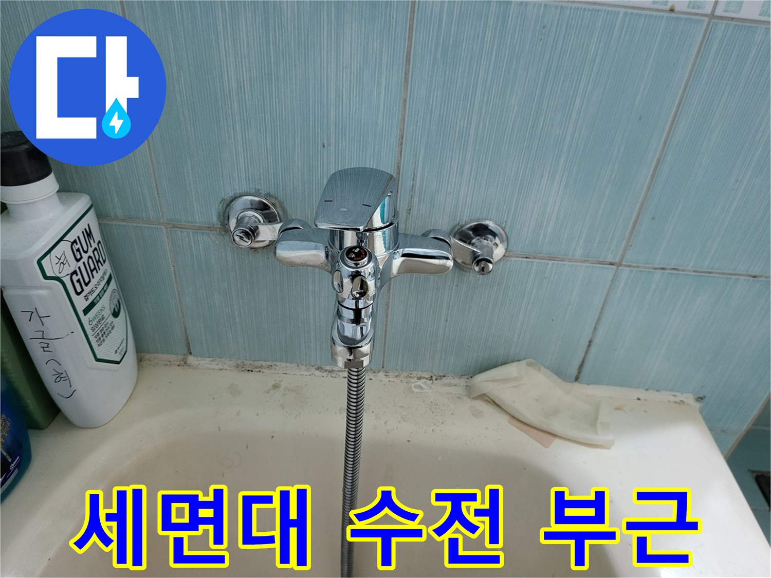 욕실 세면대에 설치된 수도꼭지와 주변 벽면입니다.