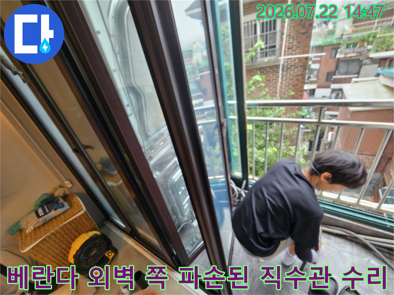 배관 수리 부위를 확인하기 위해 작업자가 베란다에 위치한 모습