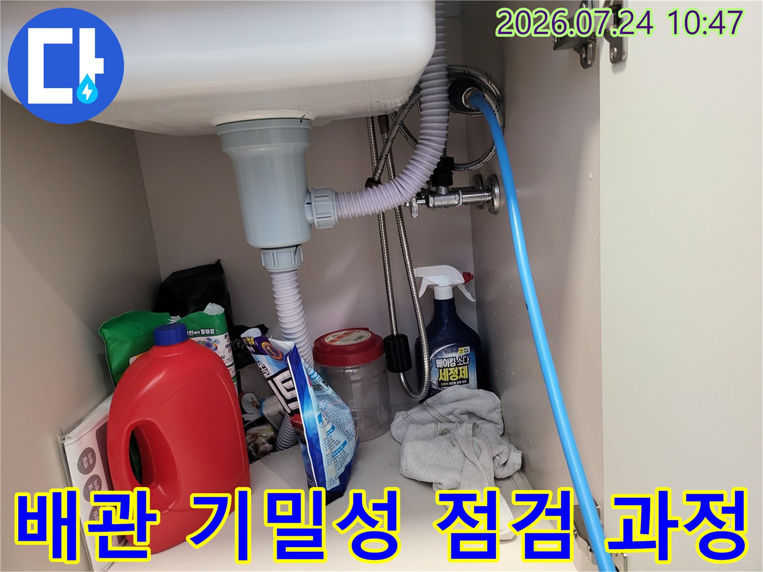 싱크대 아래 트랩과 호스가 연결된 배출 시스템 점검