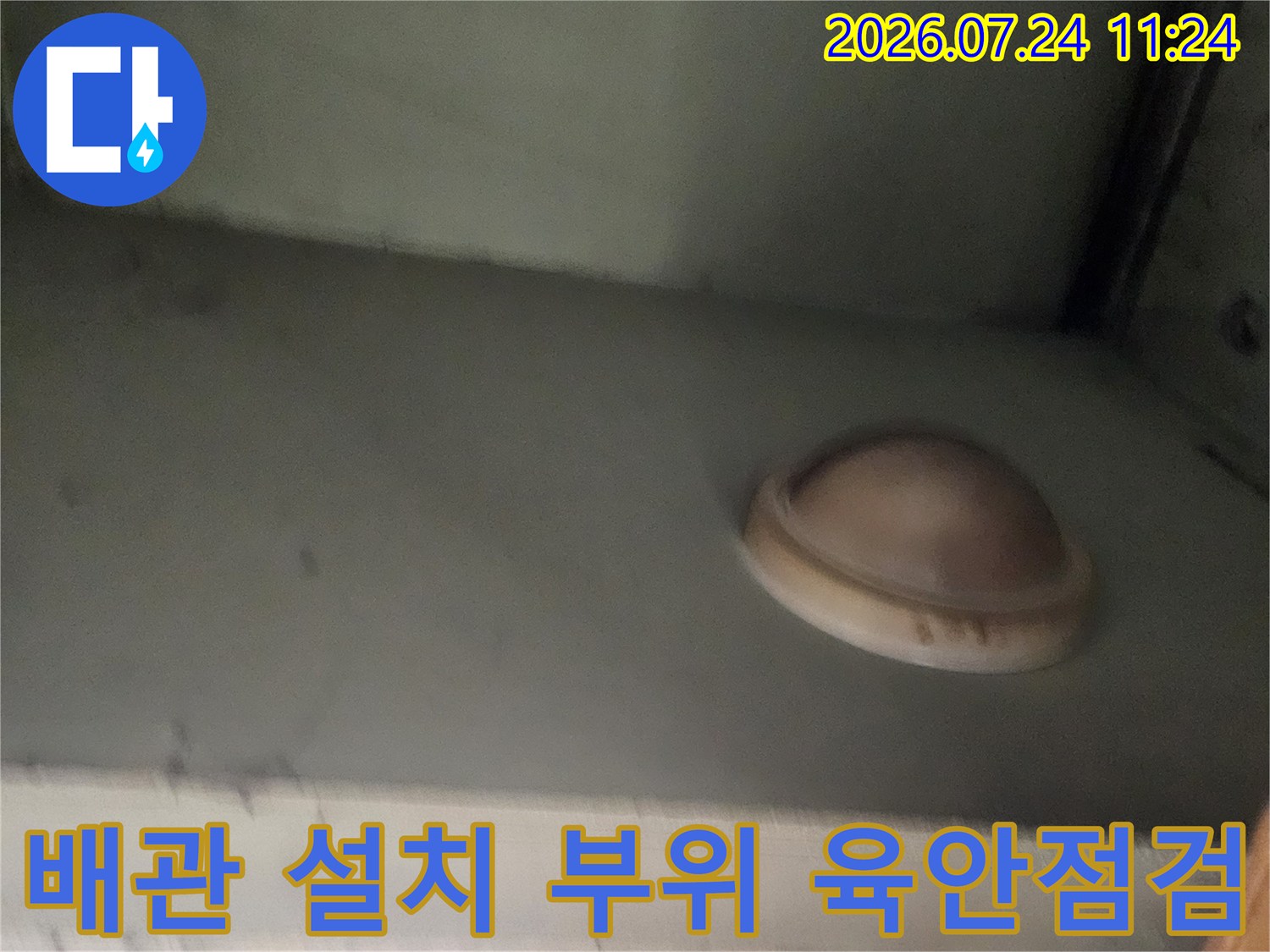 벽체에 고정된 배관 마감재와 주변 환경을 정밀하게 조사하는 모습