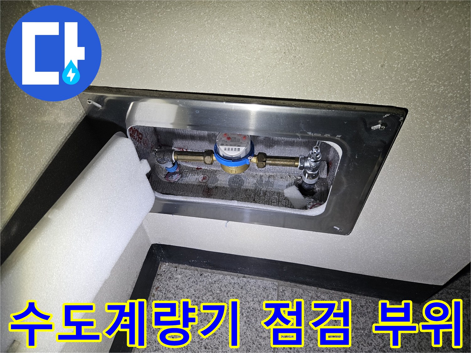 금속 덮개 안쪽에 위치한 수도계량기와 연결 배관의 상태를 확인하는 모습