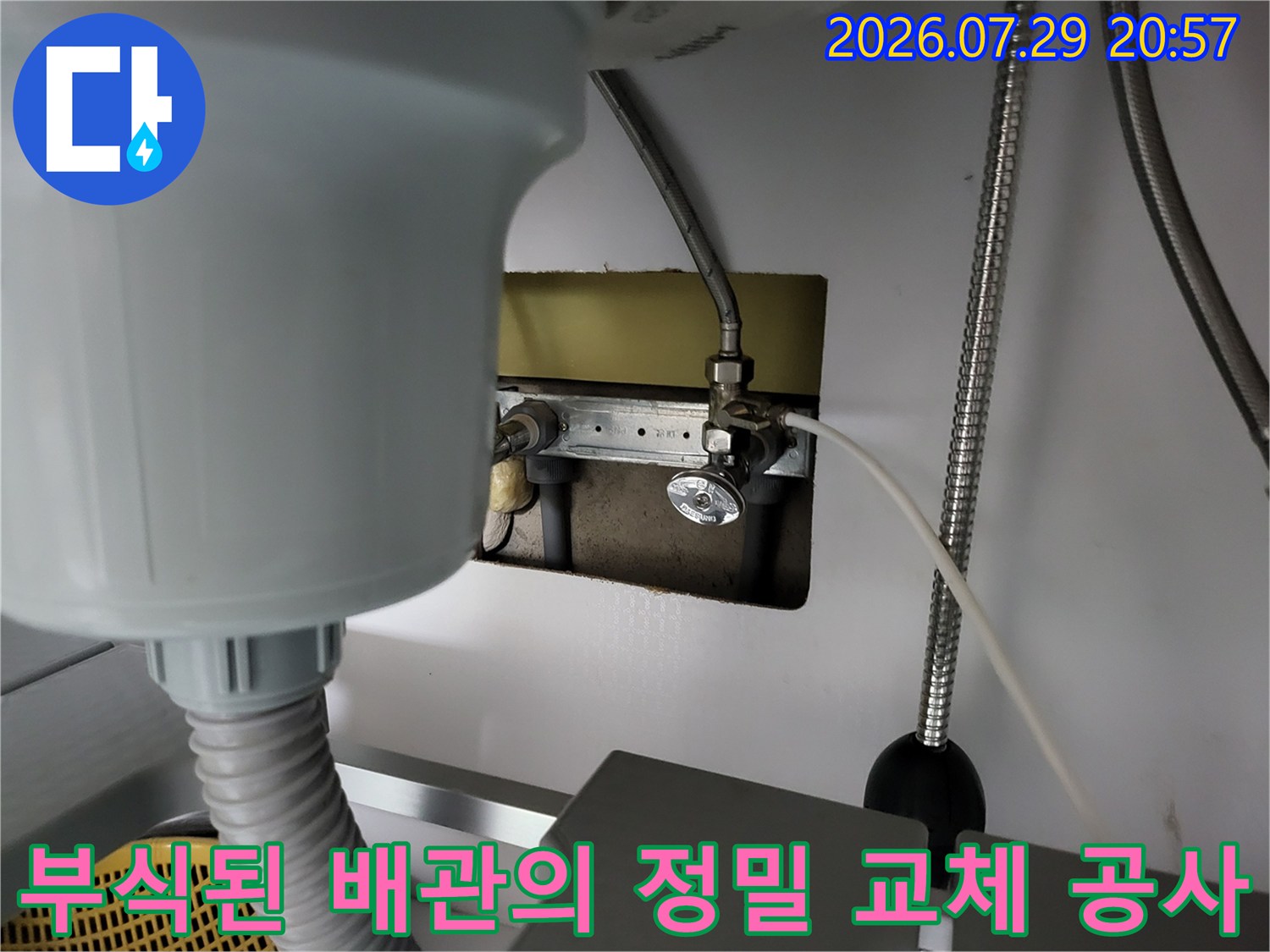 싱크대 하부 공간에서 새 온수 배관을 연결하는 전문적인 누수 수리 과정입니다.