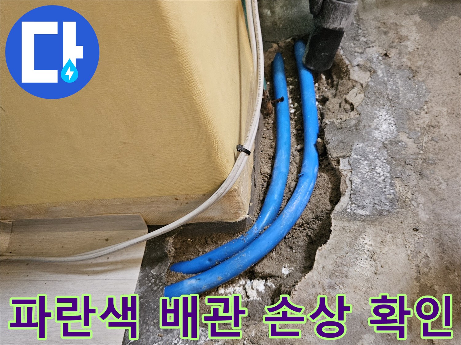 벽면 굴착 부위 내부에 노출된-손상된 파란색 수도 배관