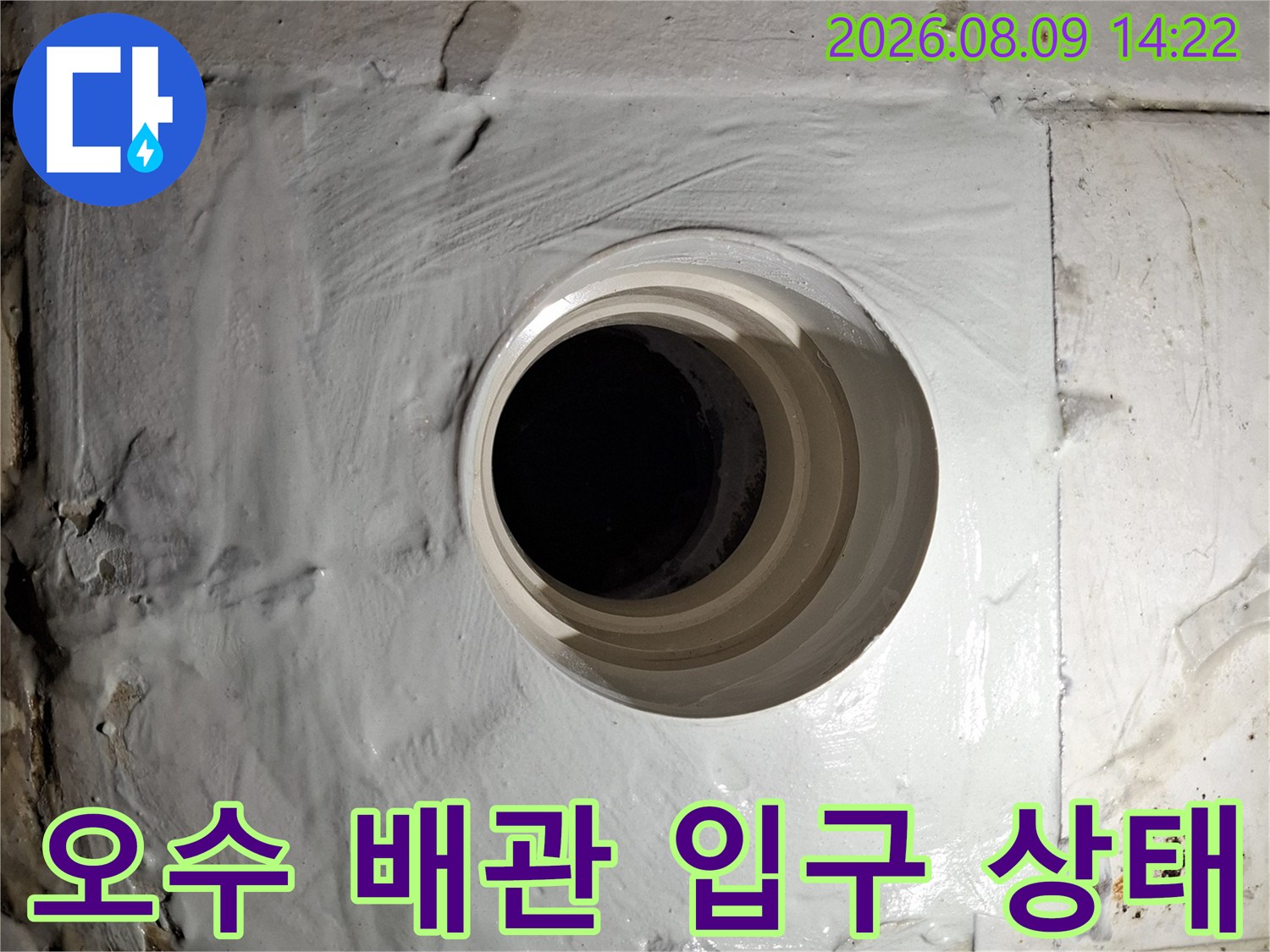 변기 탈거 후 노출된 오수 배관의 입구와 주변 마감 부위입니다.