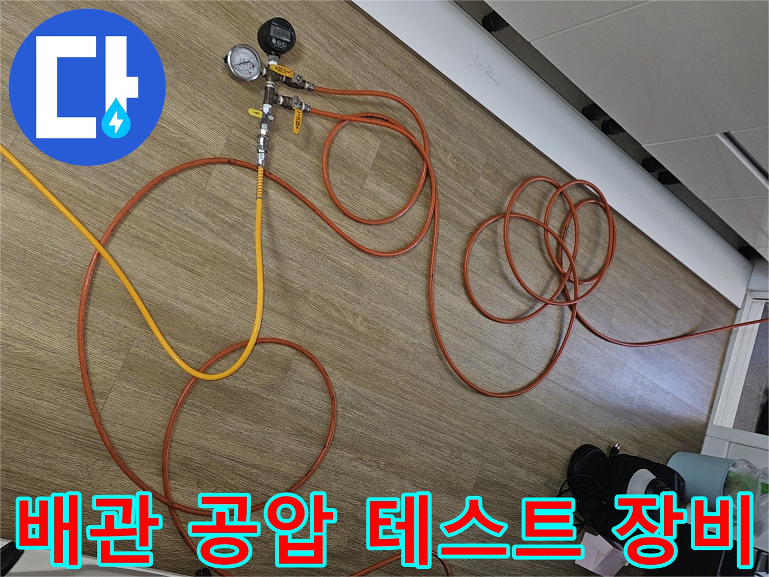바닥에 설치된-압력계와 연결된 주황색 에어 호스