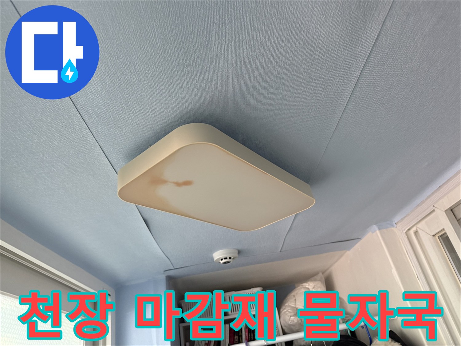중계동 아파트 천장-푸른색 마감재와 전등 주변의 갈색 누수 흔적